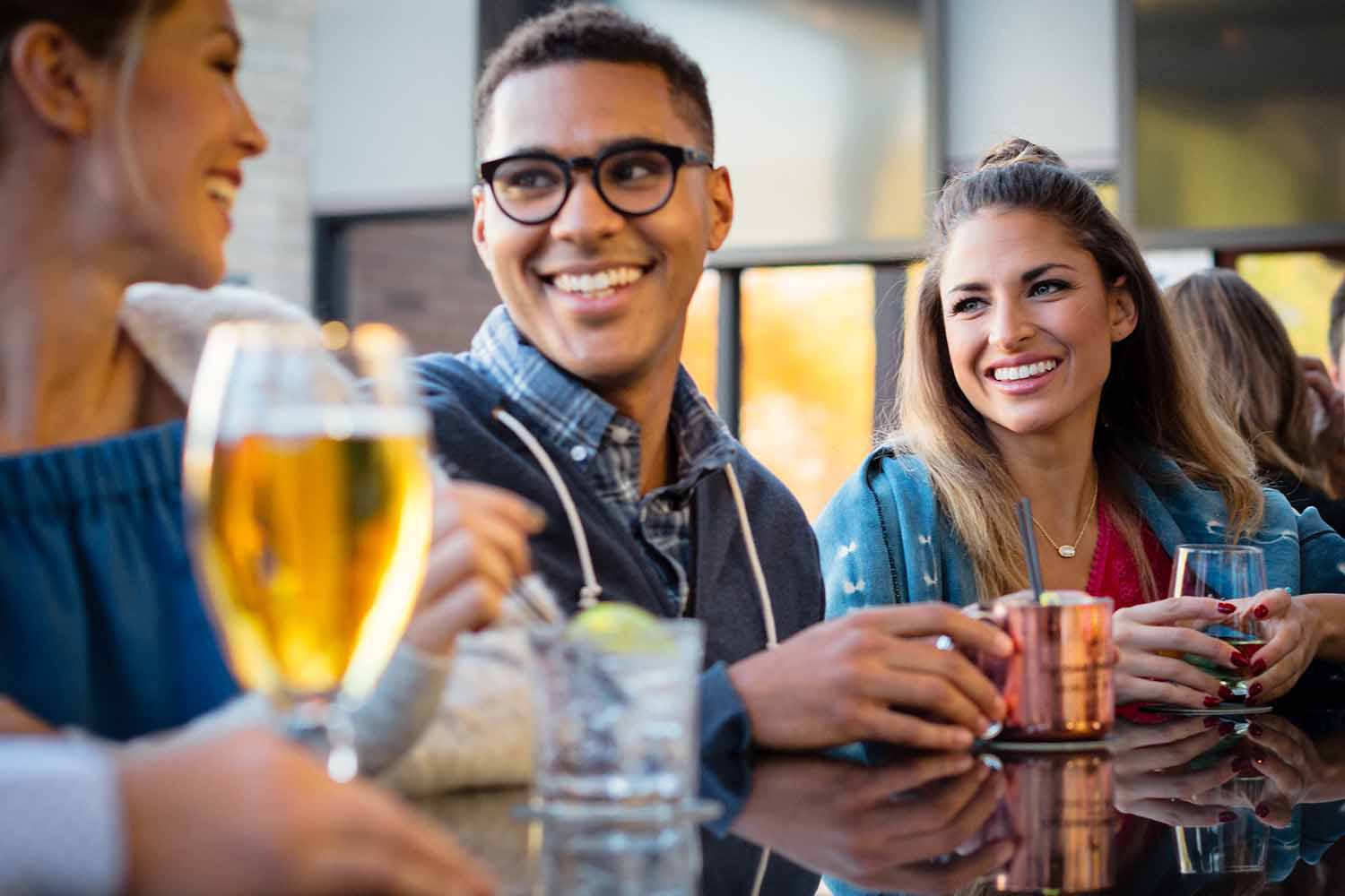  group of friends enjoying drinks at a bar