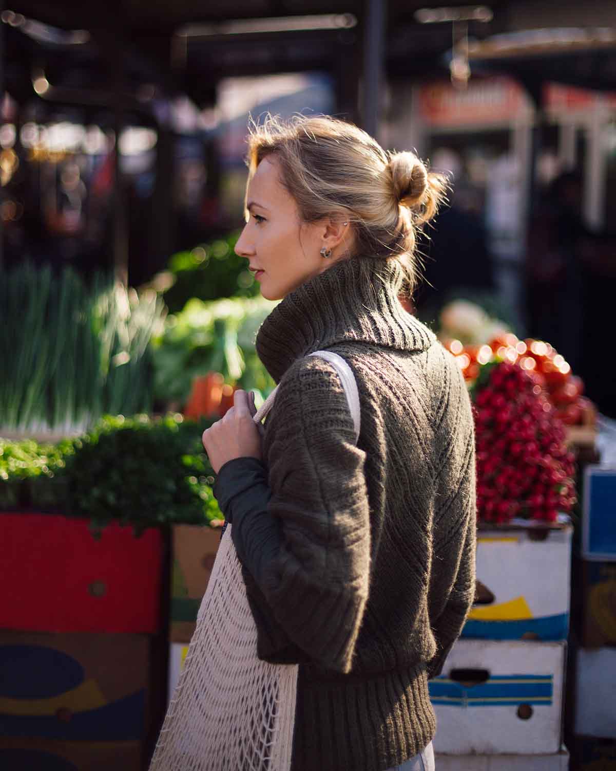 Woman at a local farmer's market holding a bag