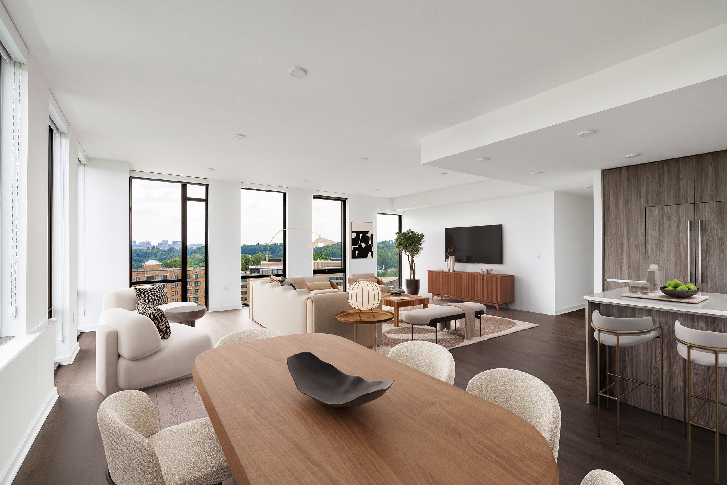A bright, open-concept penthouse living room with a caramel-toned sectional, modern lounge chairs, and floor-to-ceiling windows near a sleek kitchen.