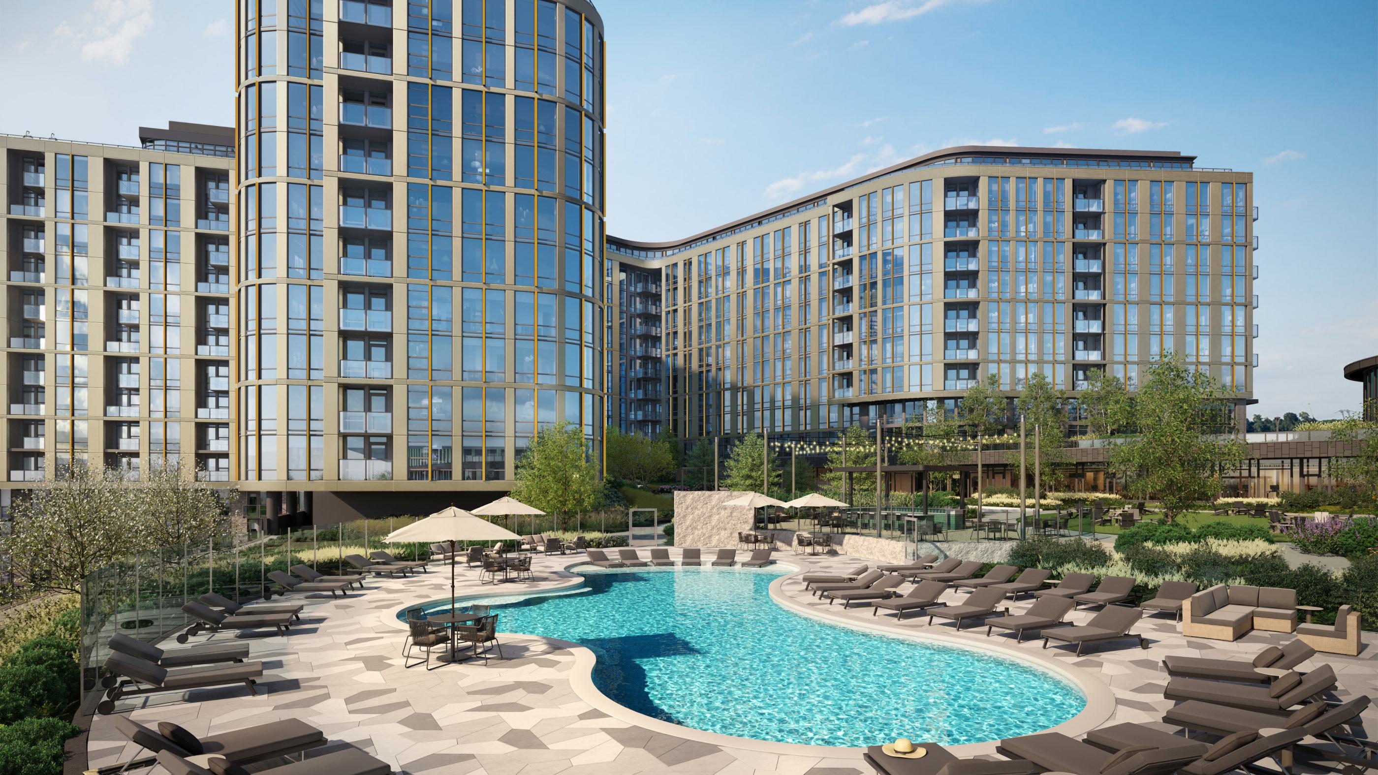 resort-style outdoor pool surrounded by lounge chairs and umbrellas, set within a landscaped courtyard of Aerie modern glass-and-metal residential building.