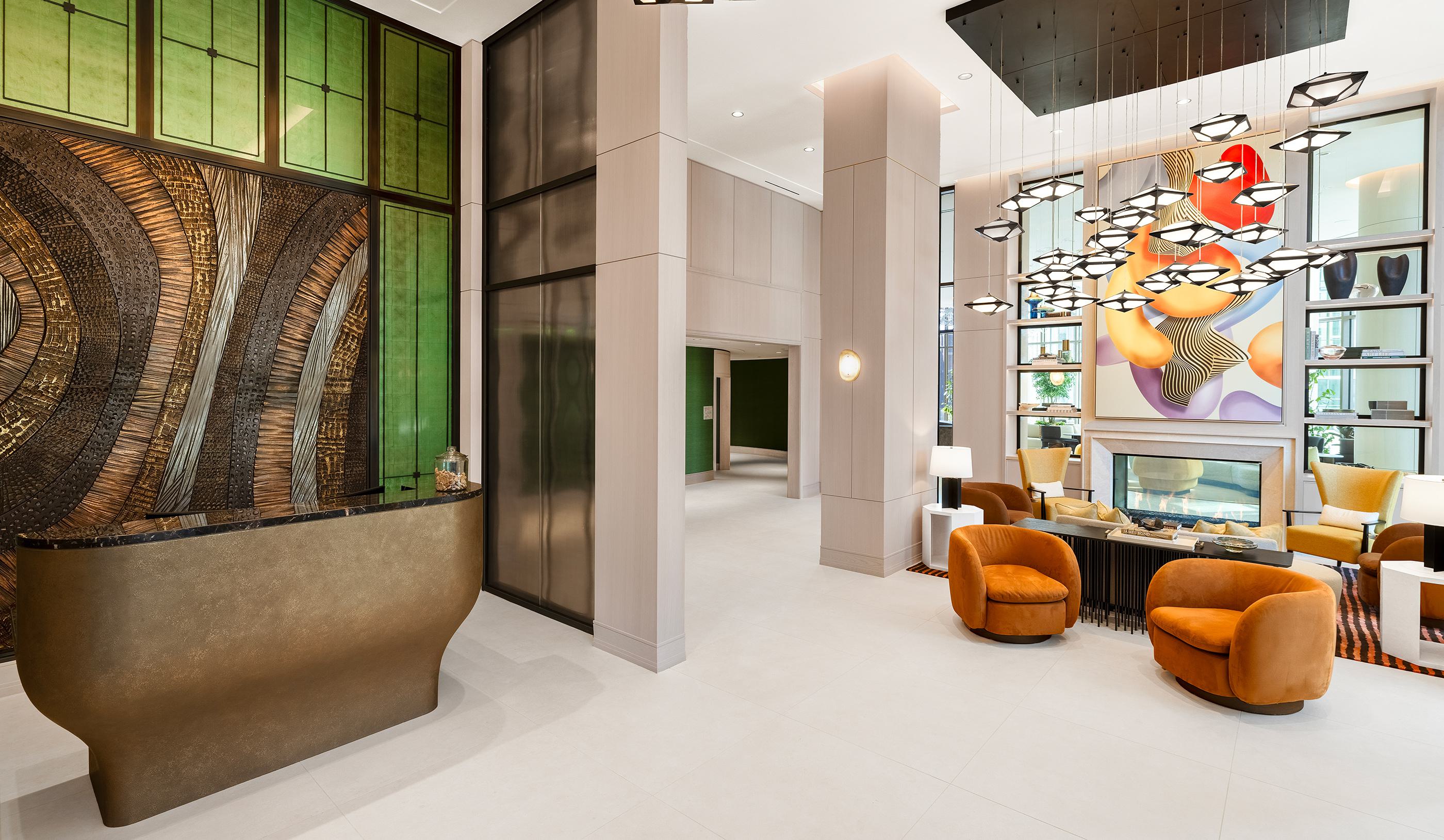 Indoor rooftop lounge with white sculptural furniture, a long bar, and vibrant multicolored chandeliers hanging beneath large skylights.
