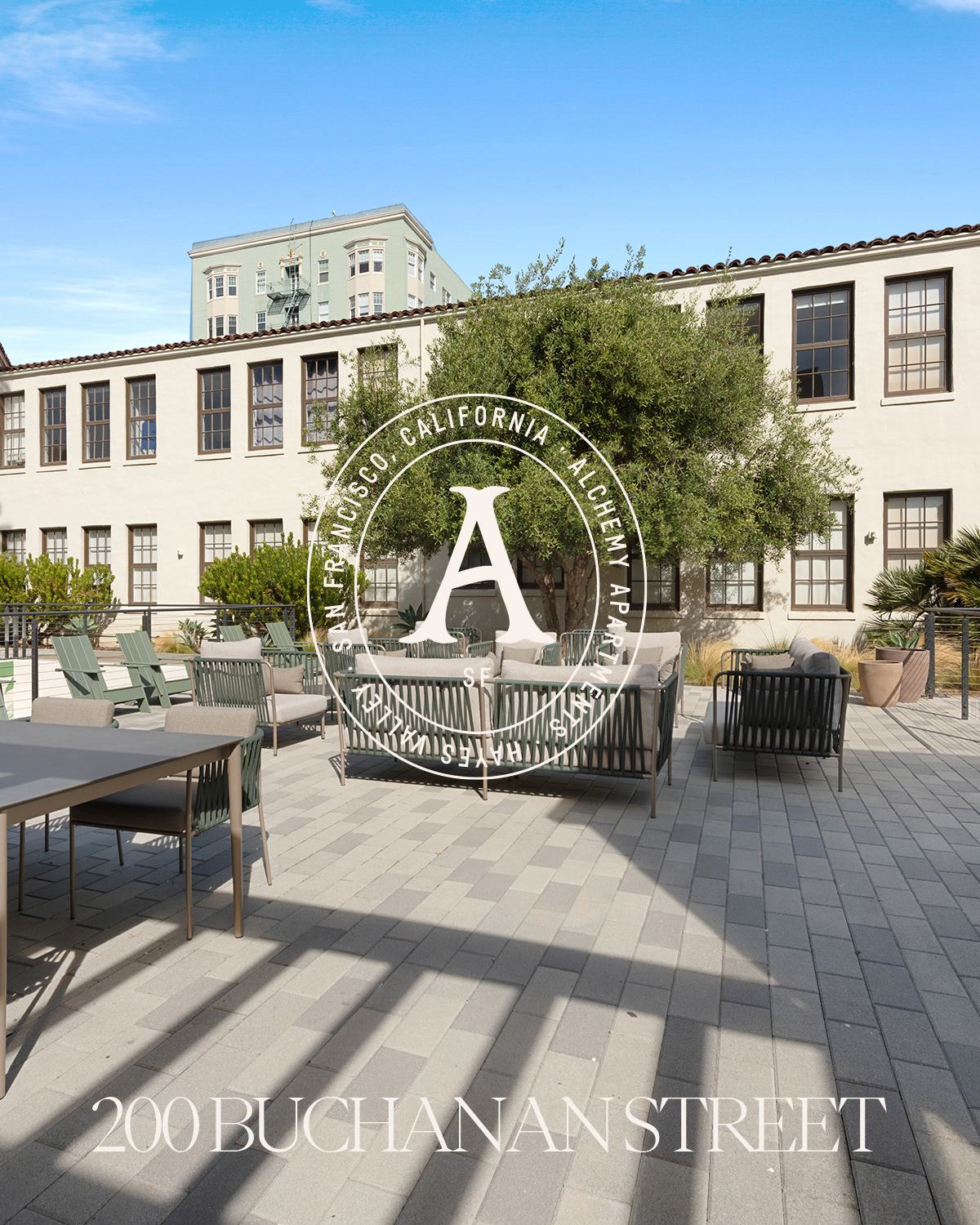 Exterior of Alchemy Apartments with landscaped courtyard and lounge seating