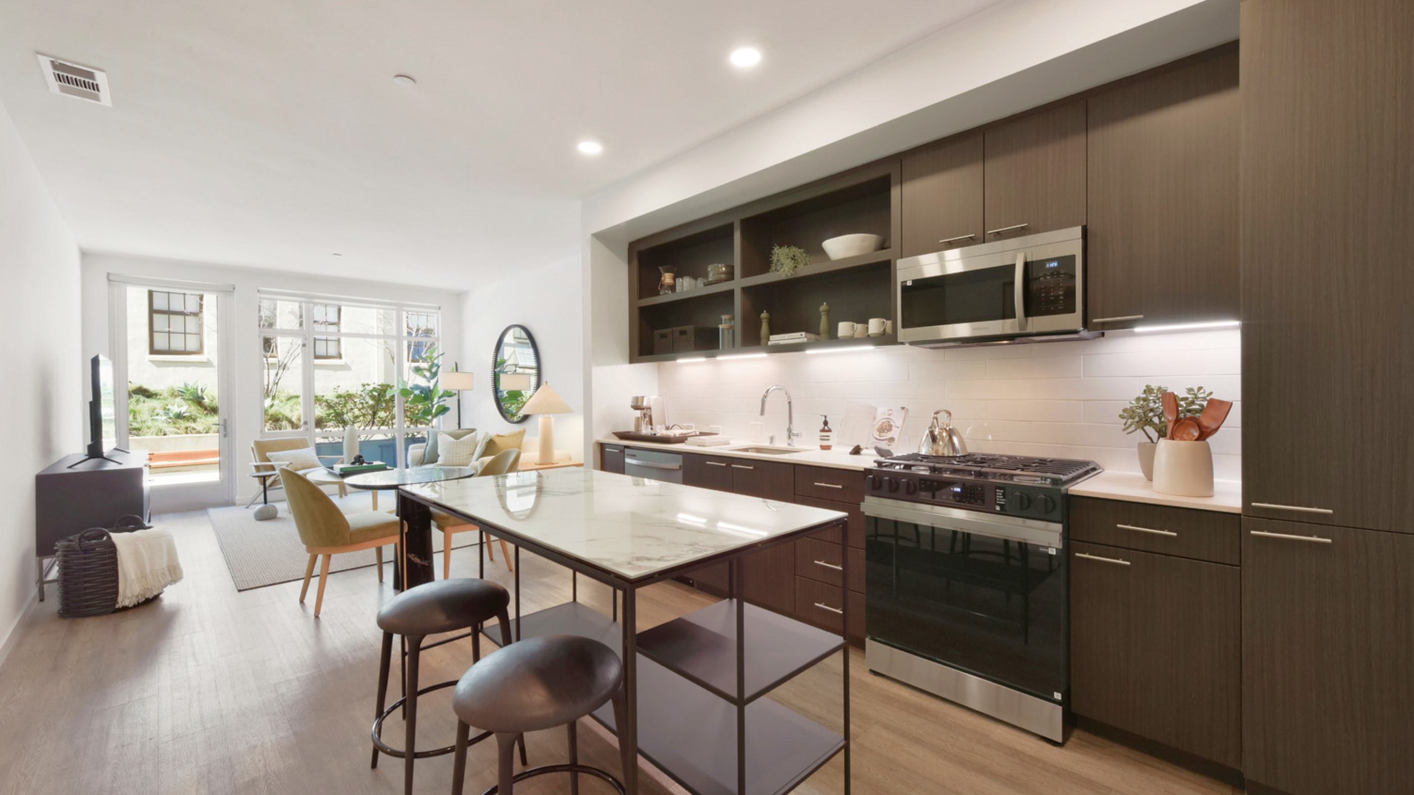 Bright, modern living room with natural light streaming through a floor-to-ceiling window.