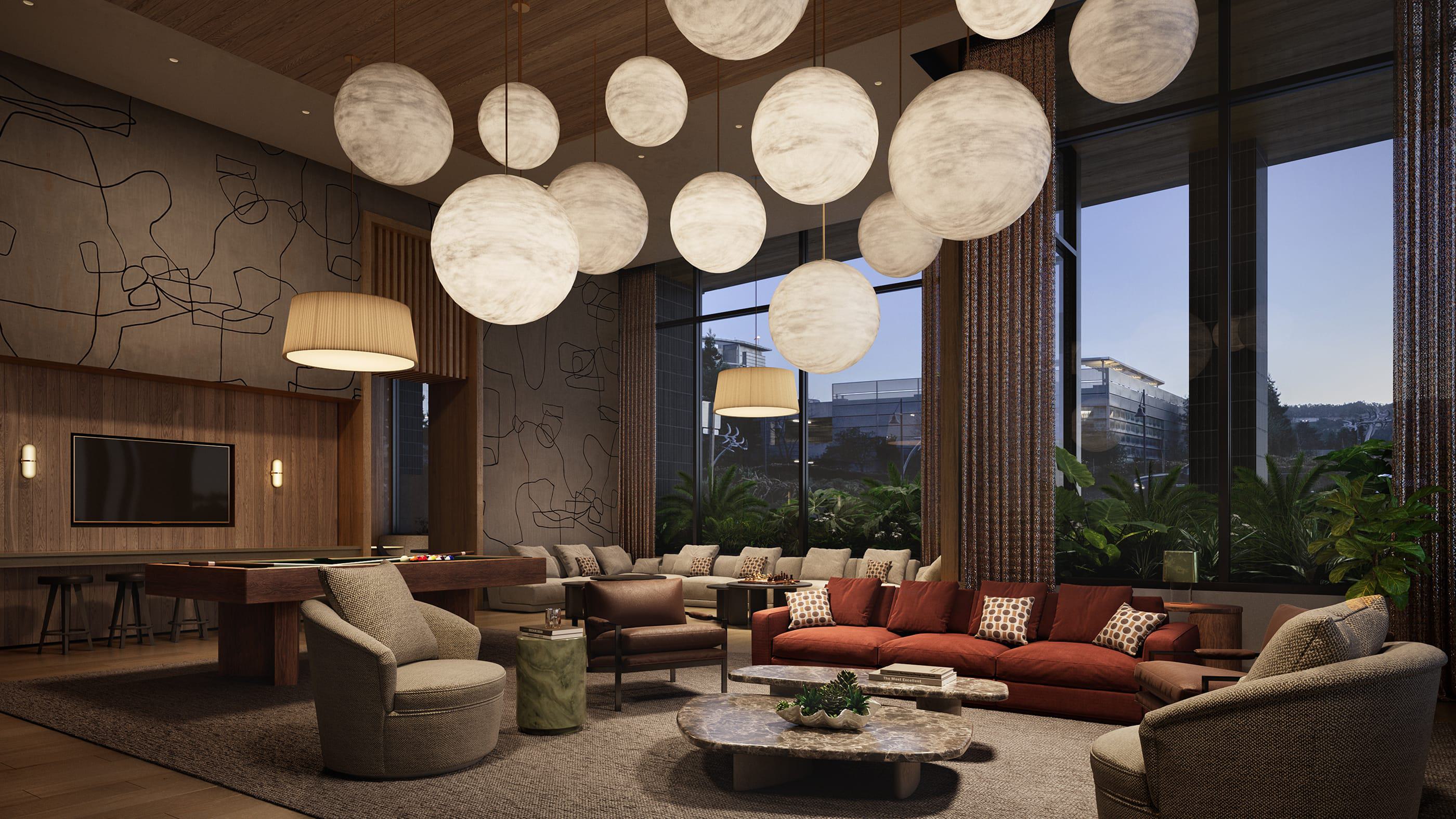 A warm, inviting lounge space with plush seating, a pool table, and abstract globe pendant lights. Tall windows frame lush greenery and evening views of modern buildings, creating an ideal setting for relaxed social gatherings.