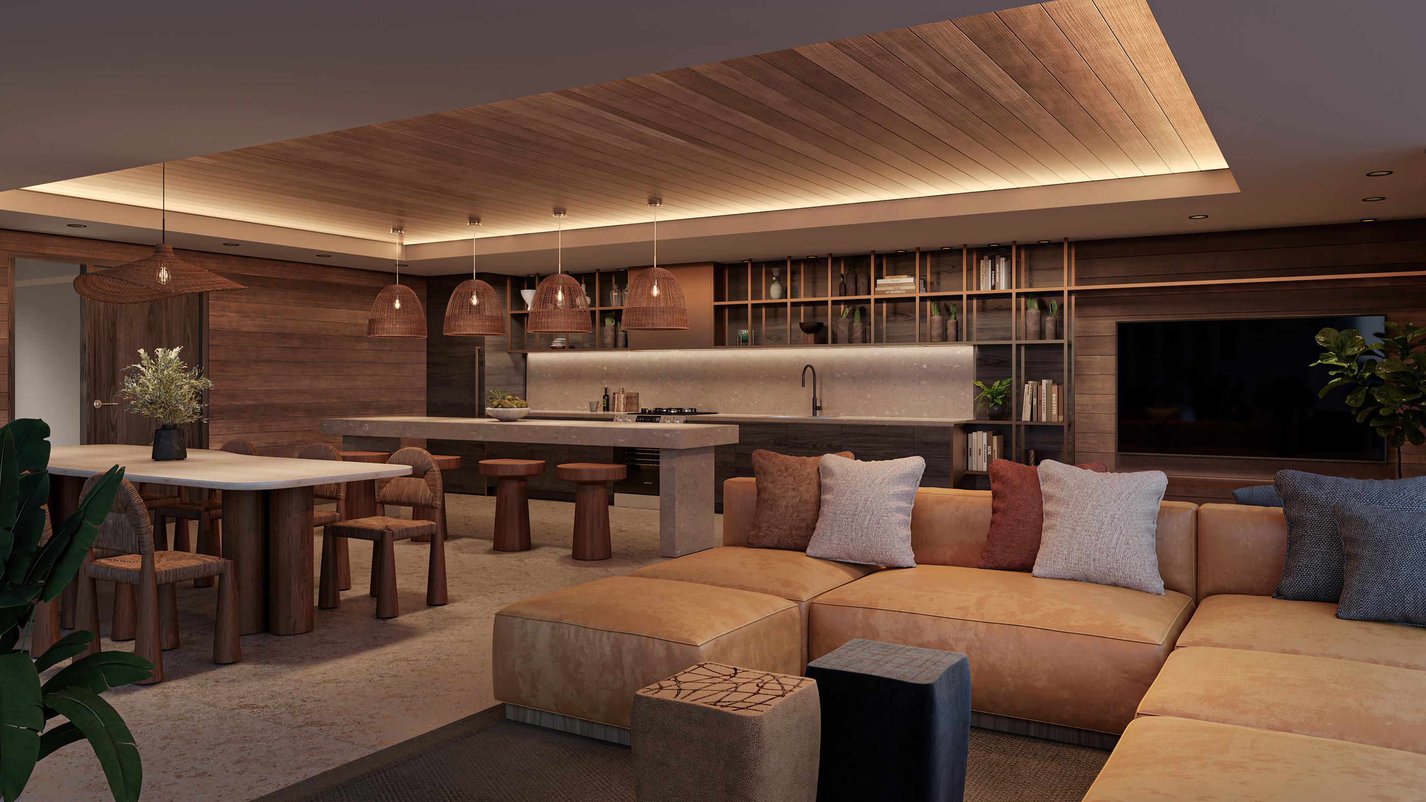 Warm-toned communal dining lounge and kitchen with wood-paneled walls, pendant lighting, long dining tables, open shelving, and a cozy sectional seating area.