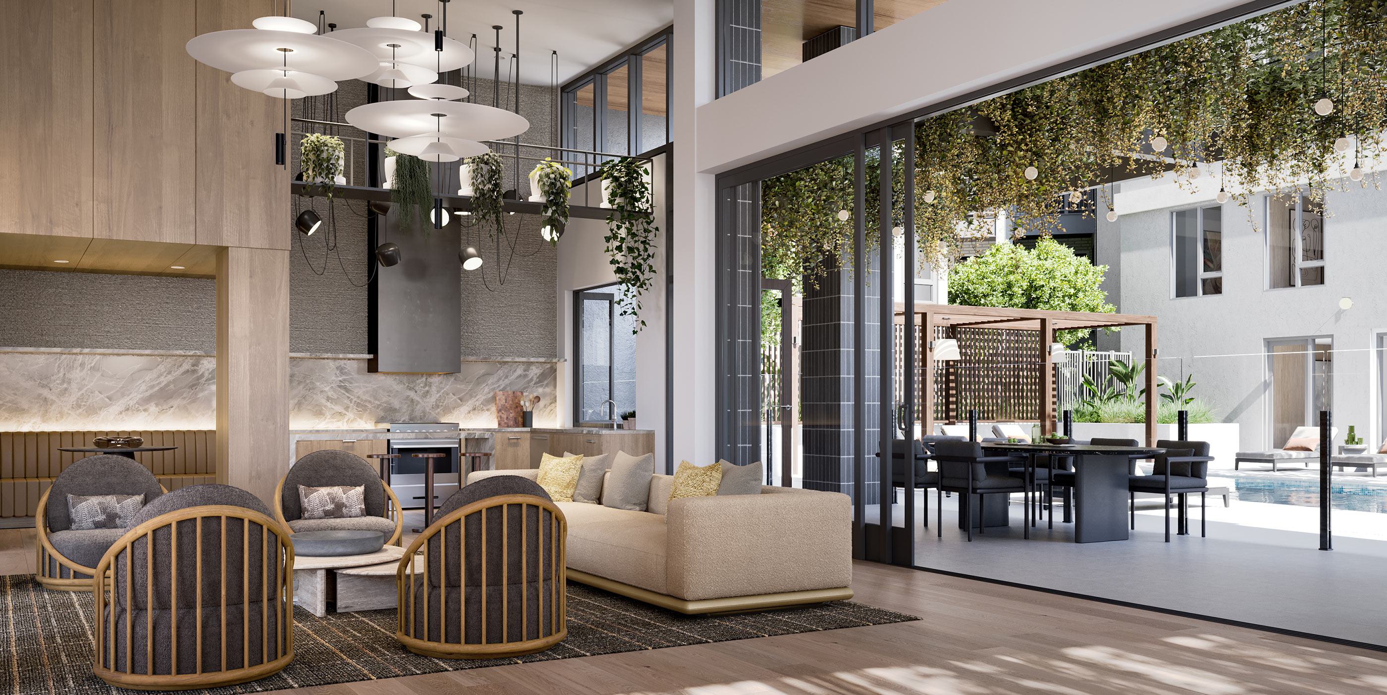 Stylish lounge at Revery with modern seating, pendant lighting, and greenery overhead, opening seamlessly to an outdoor pool deck with shaded cabanas and dining areas.