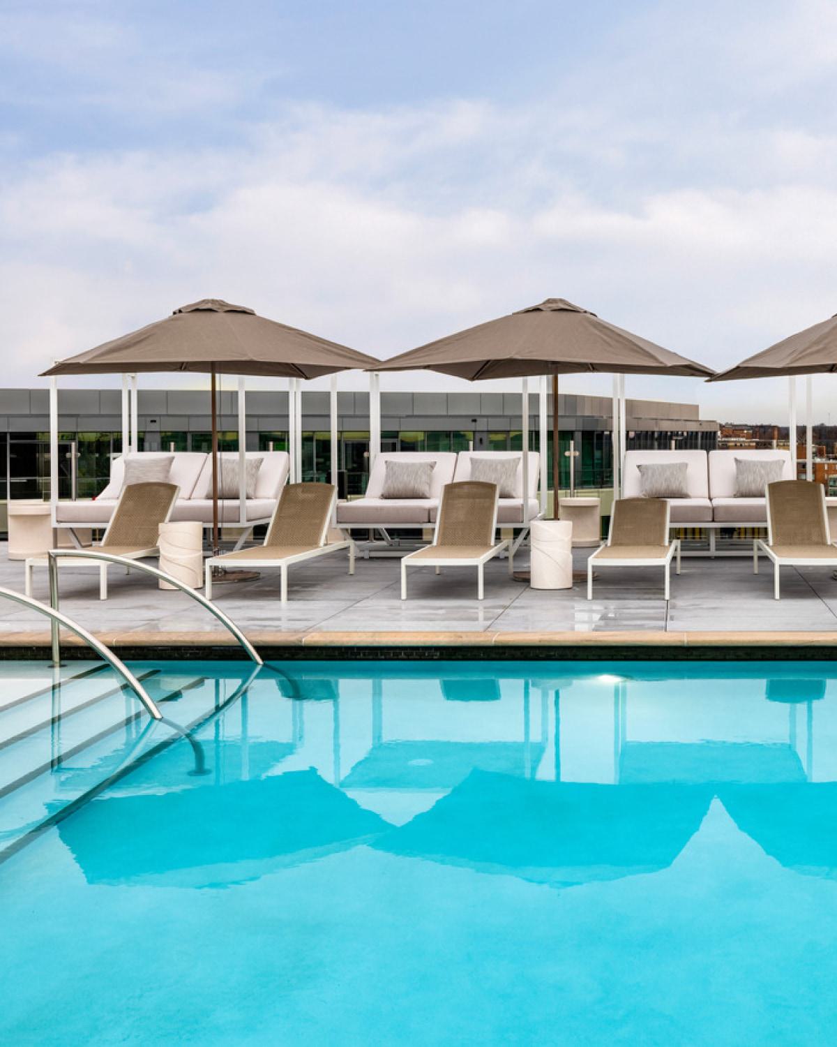 Expansive pool and deck with lounge chairs.