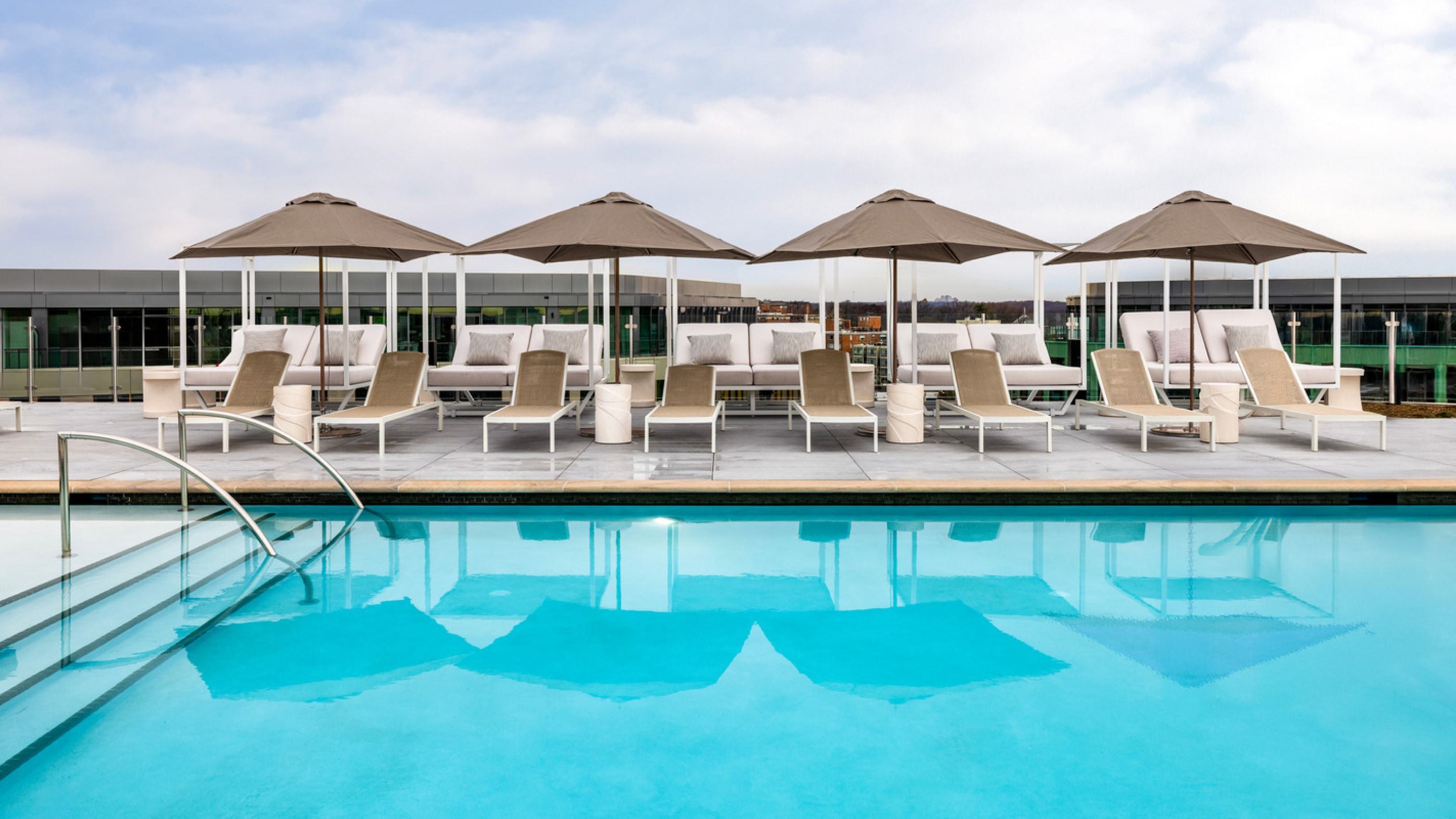 Expansive pool and deck with lounge chairs.