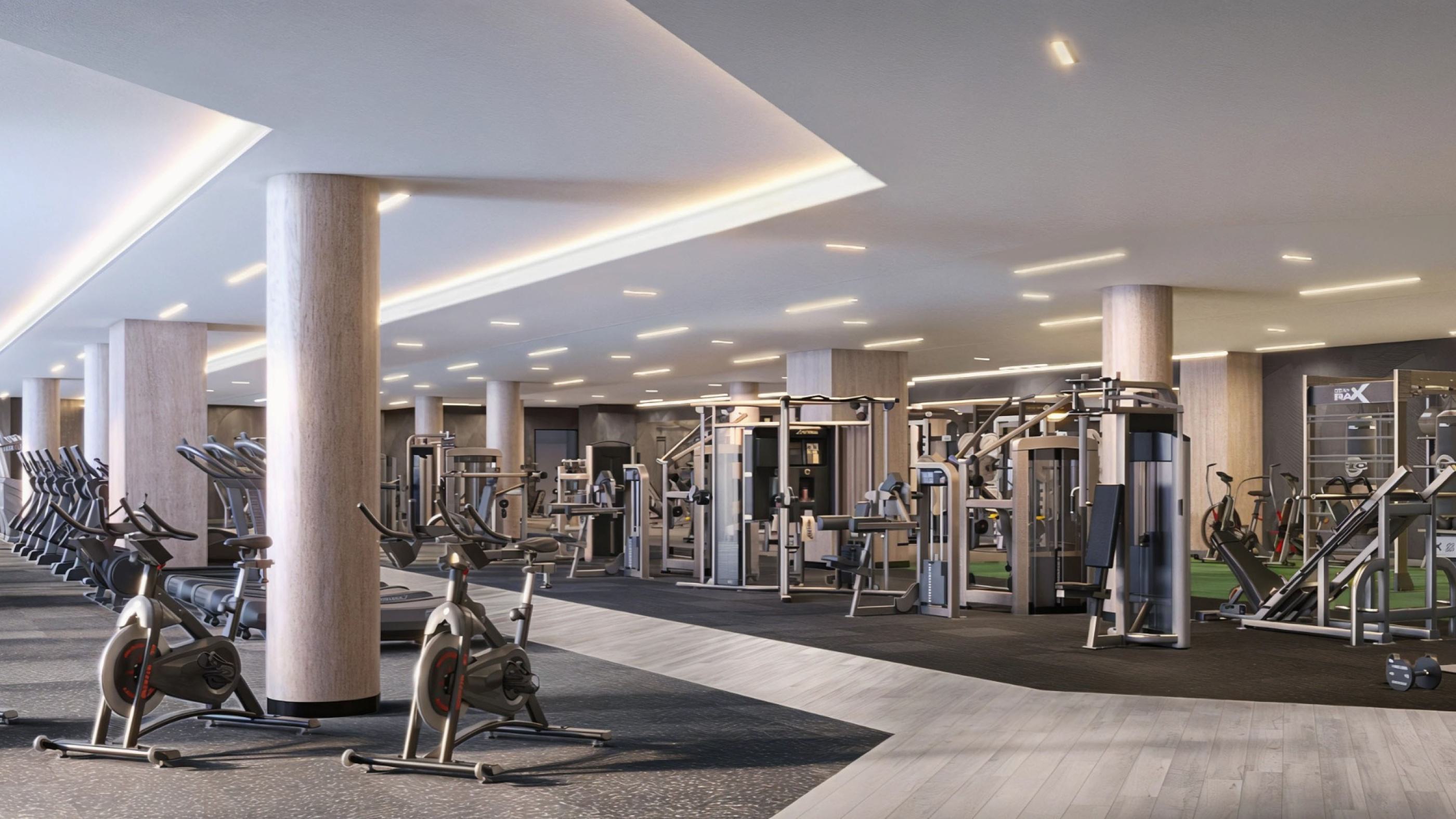 Expansive fitness center at Zephyr in Woodley Park, DC, featuring rows of cardio machines, strength-training equipment, spin bikes, and functional training zones in a modern, well-lit space with sleek wood and stone finishes.