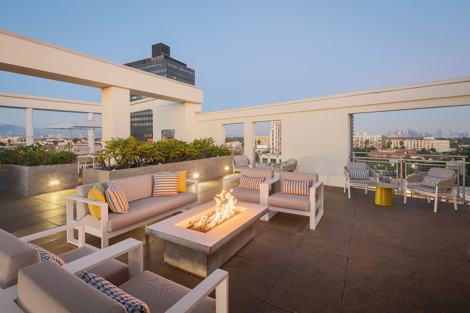 Bright, modern resident lounge featuring blue accent walls, gold lighting, and contemporary seating areas.