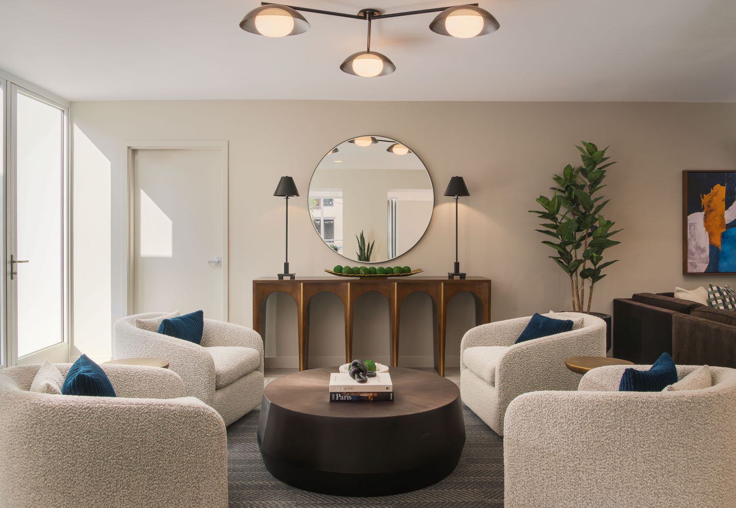 Bright, modern resident lounge featuring blue accent walls, gold lighting, and contemporary seating areas.