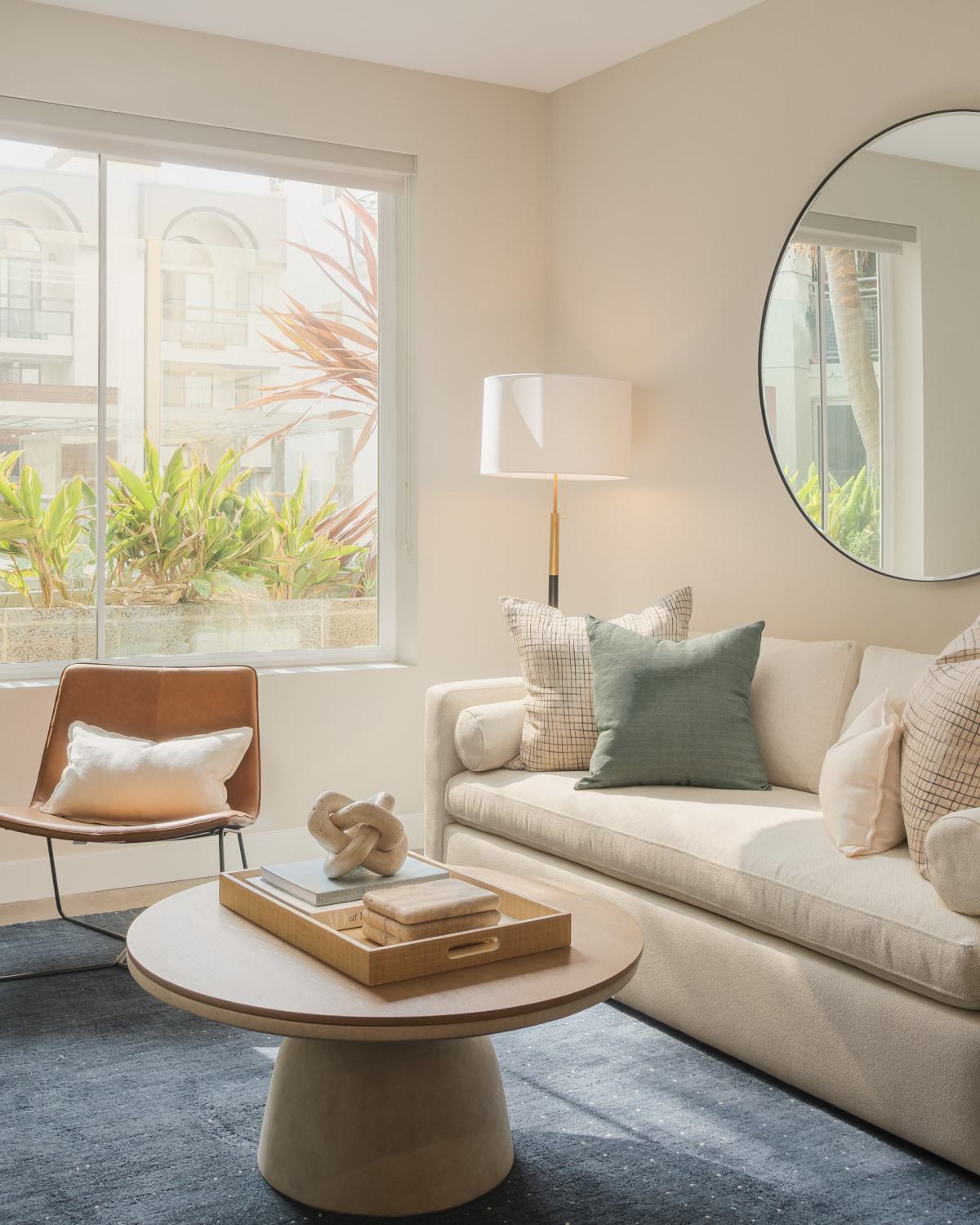 Glass of amber whiskey on a sunlit marble table.