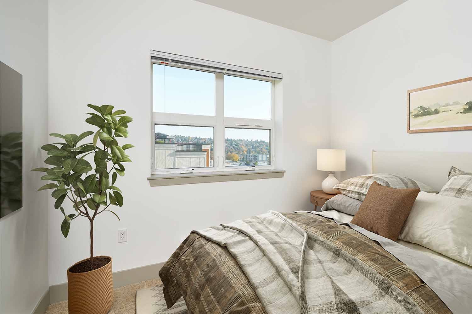 Cozy bedroom with neutral plaid bedding, a potted plant, and a large window offering natural light and views of a green hillside in Ballard in the distance.