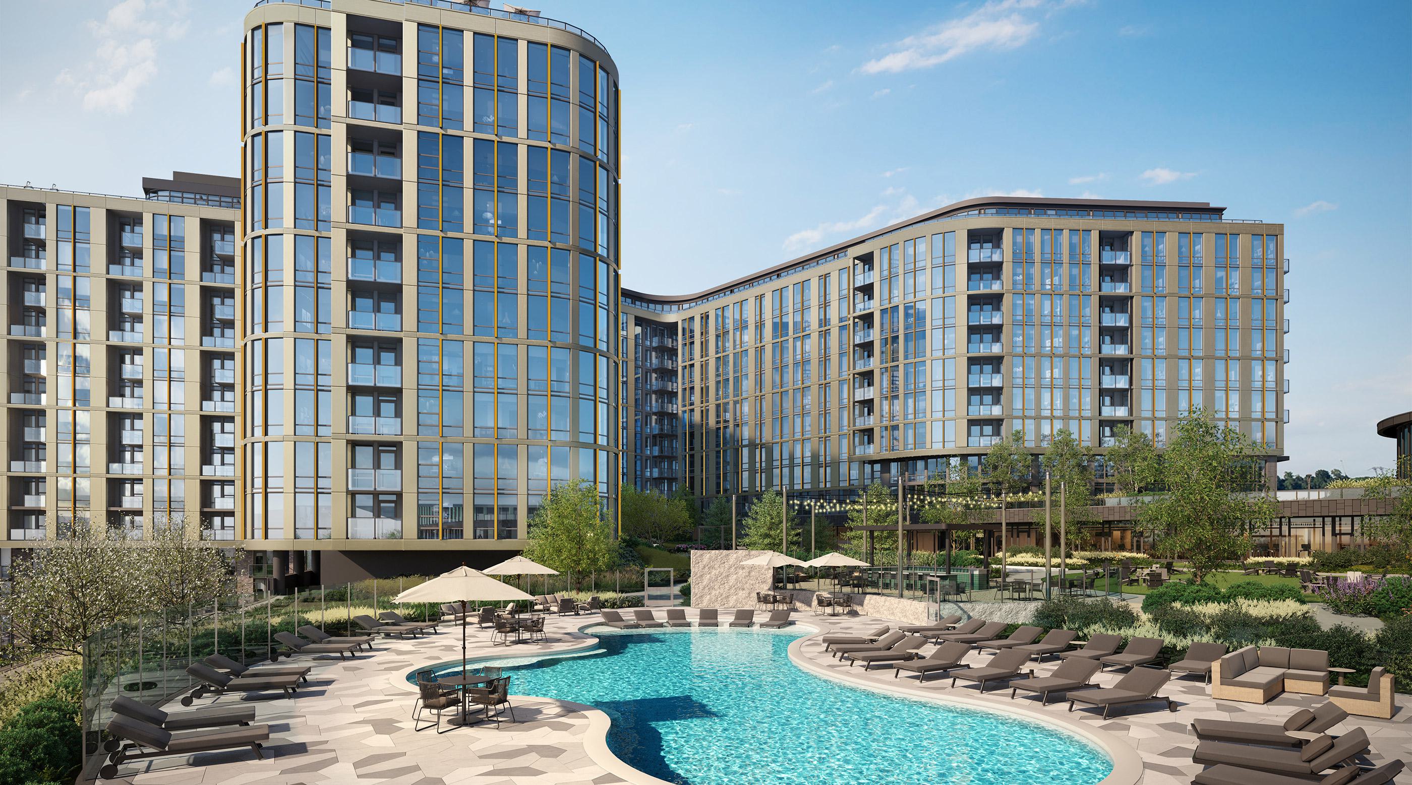 Courtyard pool at Zephyr in Woodley Park, DC, surrounded by modern lounge chairs, umbrellas, and lush landscaping, framed by the sleek glass façade of the high-rise building.