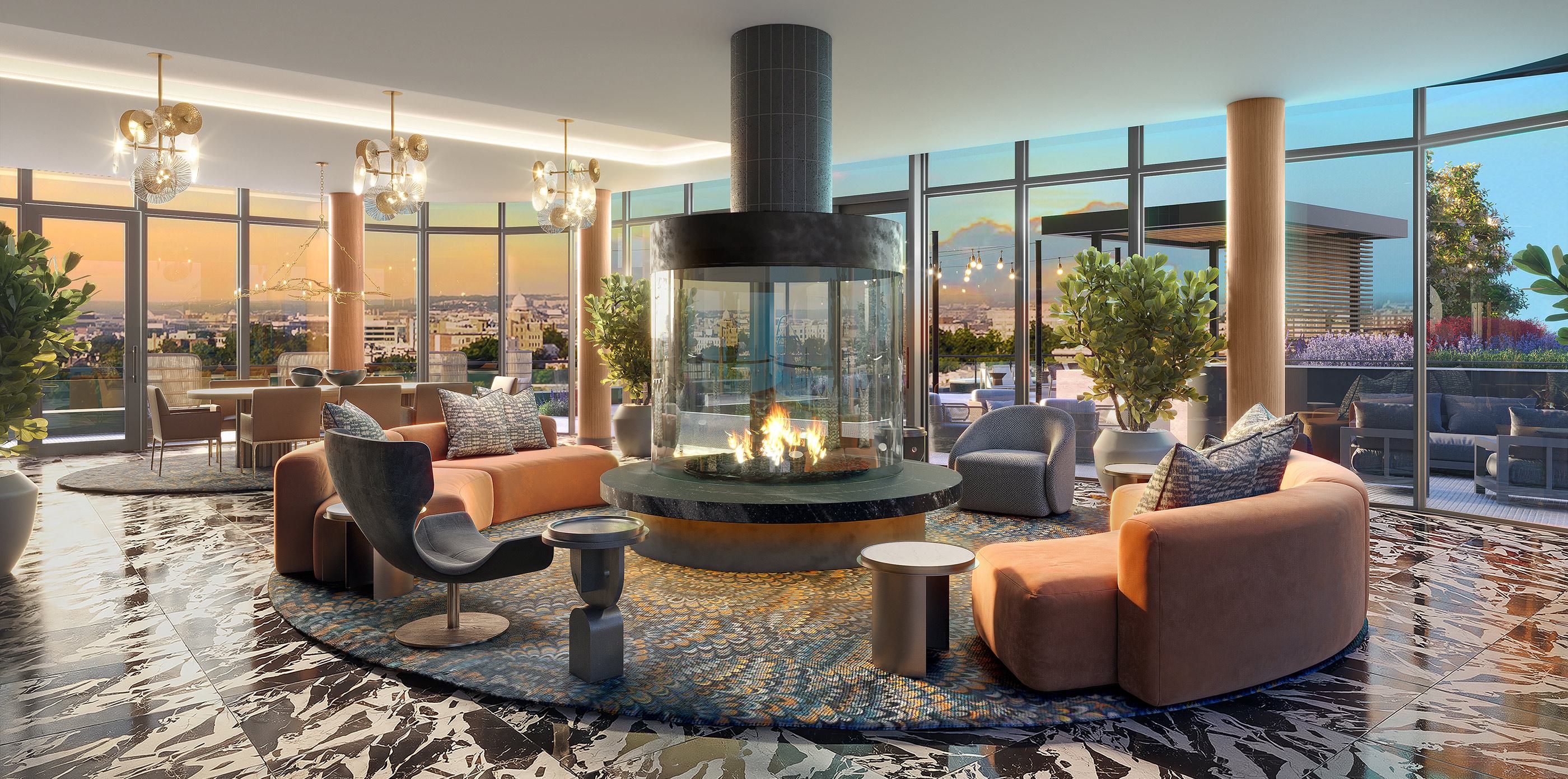 The Observatory lounge at Zephyr in Woodley Park, DC, featuring a circular glass fireplace, plush seating, and floor-to-ceiling windows opening to panoramic views of the city skyline, including the Washington Monument at sunset.
