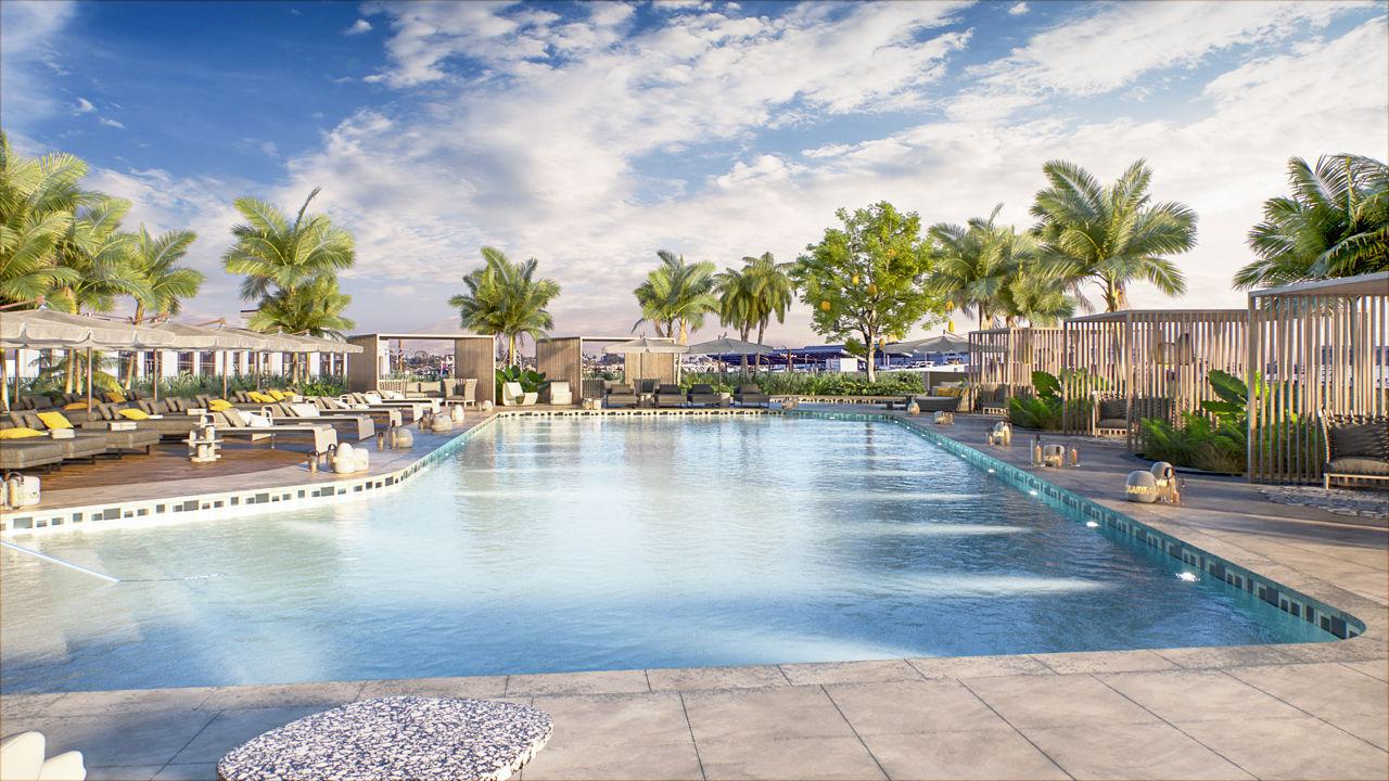 Large rooftop pool with geometric design, surrounded by palm trees, chaise lounges with yellow accents, wooden pergolas, and vertical slat privacy screens under blue sky with clouds