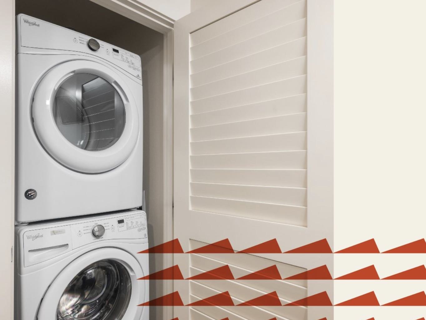 Stacked Whirlpool washer and dryer inside an apartment at Chroma, enclosed by a white louvered door for a clean, space-saving design.