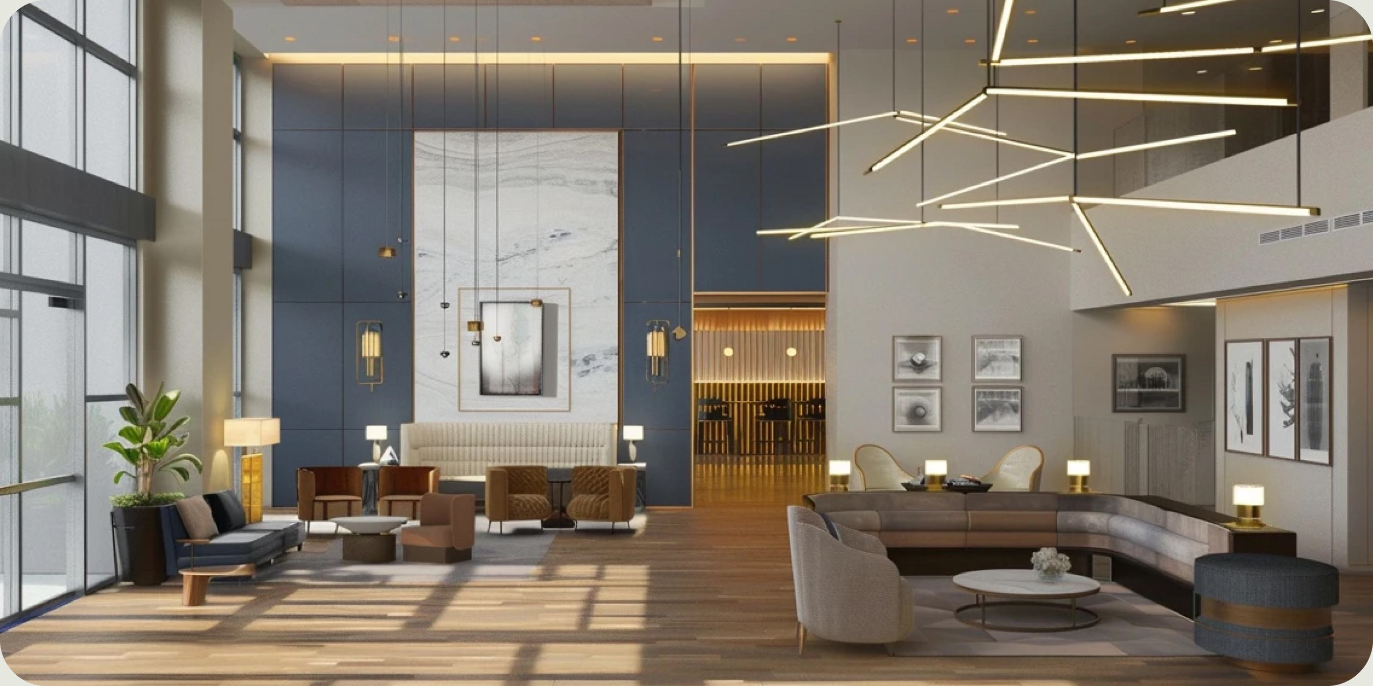 Modern apartment lobby with high ceilings, marble accents, statement lighting, and contemporary seating.