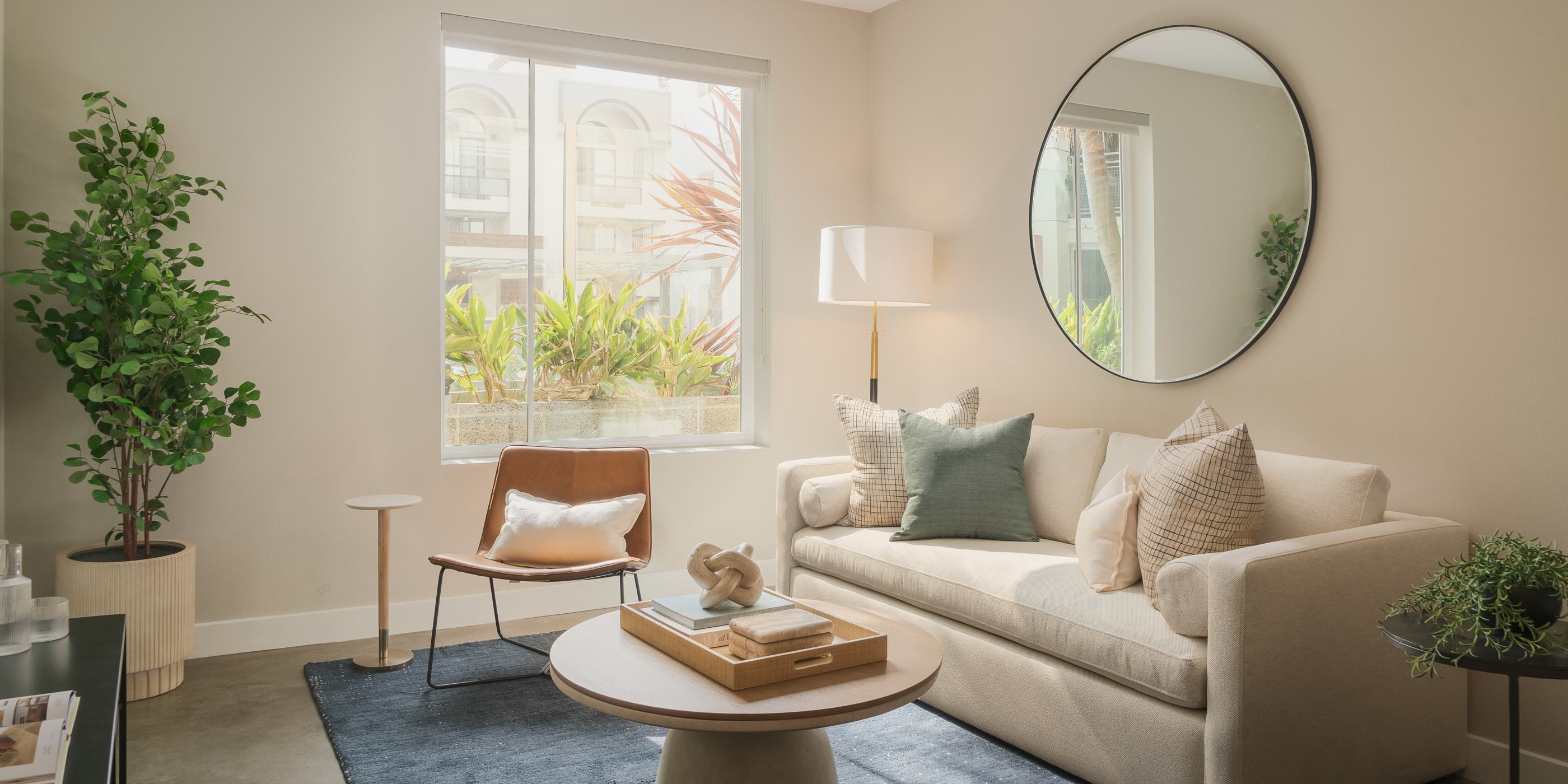Mid-century cabinet with a vintage record player, striped planter, and framed wall art.