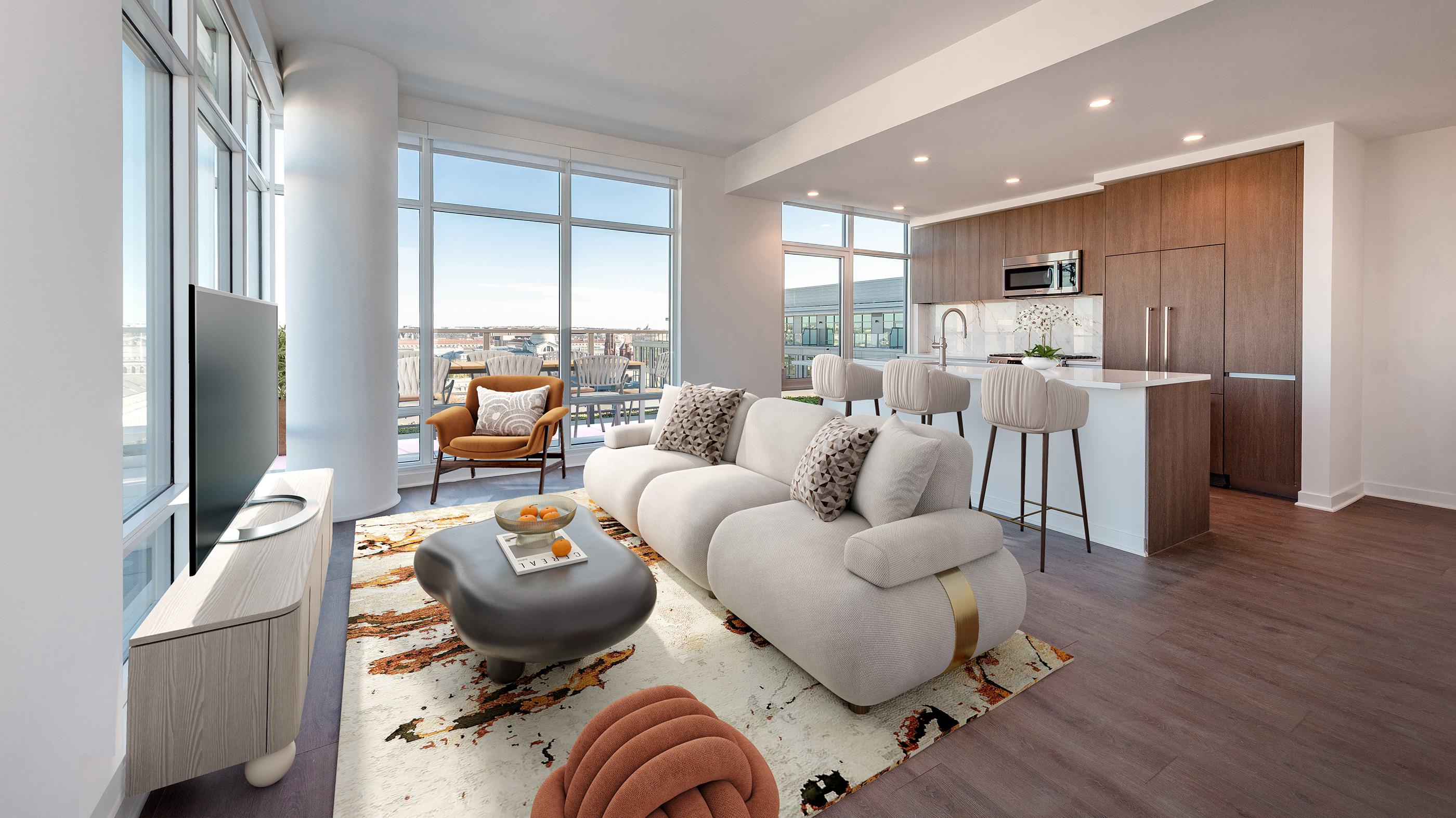 Modern DC apartment living room with floor-to-ceiling windows, plush curved sofa, and open kitchen with wood cabinetry and bar seating.