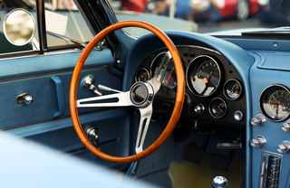 A leather steering wheel in a vintage car