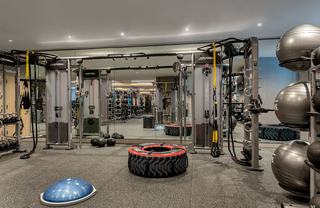 The Hale fitness center’s functional training area featuring Life Fitness cable machines, TRX suspension straps, free weights, medicine balls, and balance trainers, all set against mirrored walls and durable rubber flooring for strength and mobility workouts.