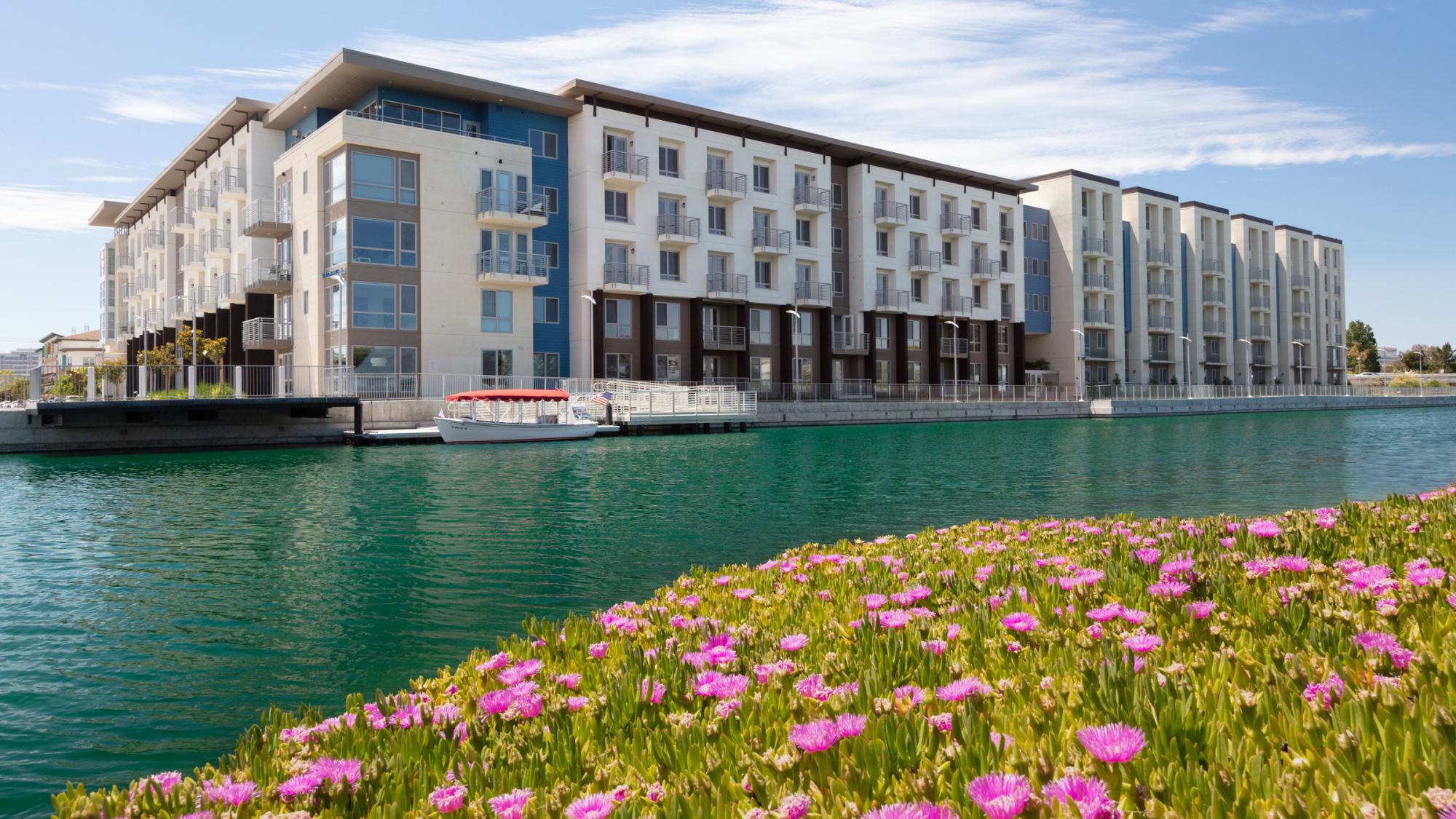 The Triton apartments in Foster City situated directly on the lagoon, with waterfront promenade and boat dock access.