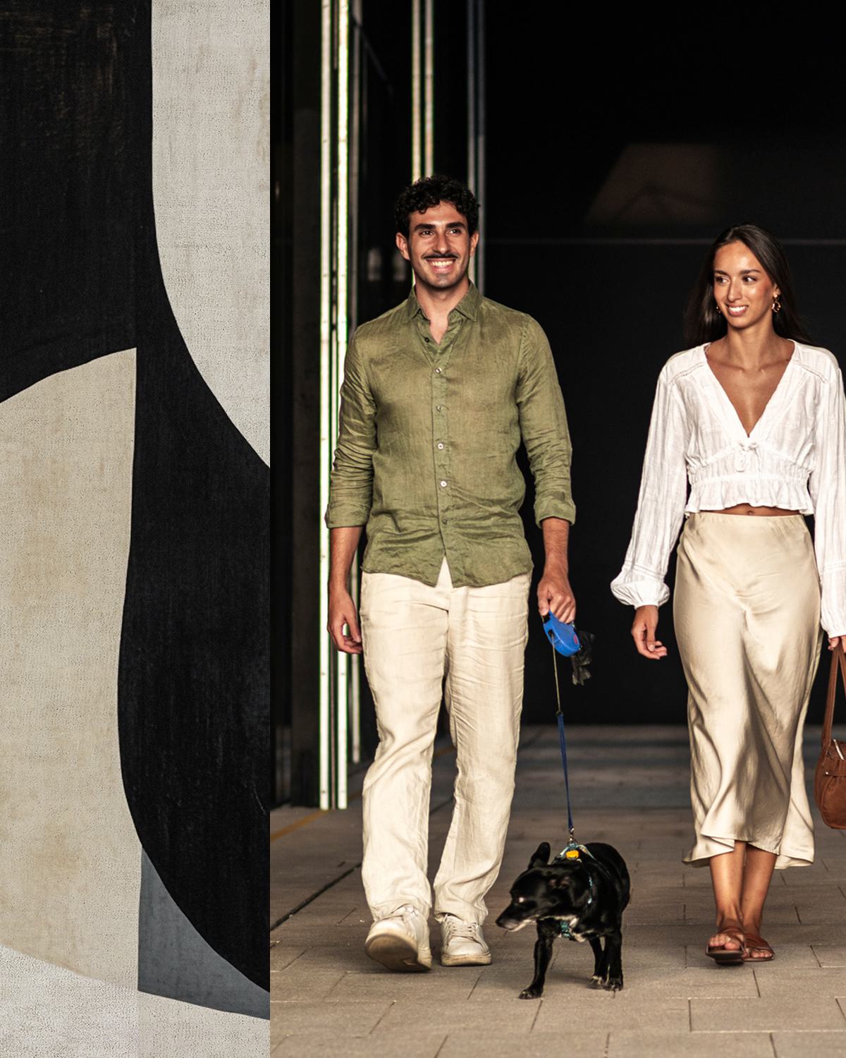 Couple walking dog in the city