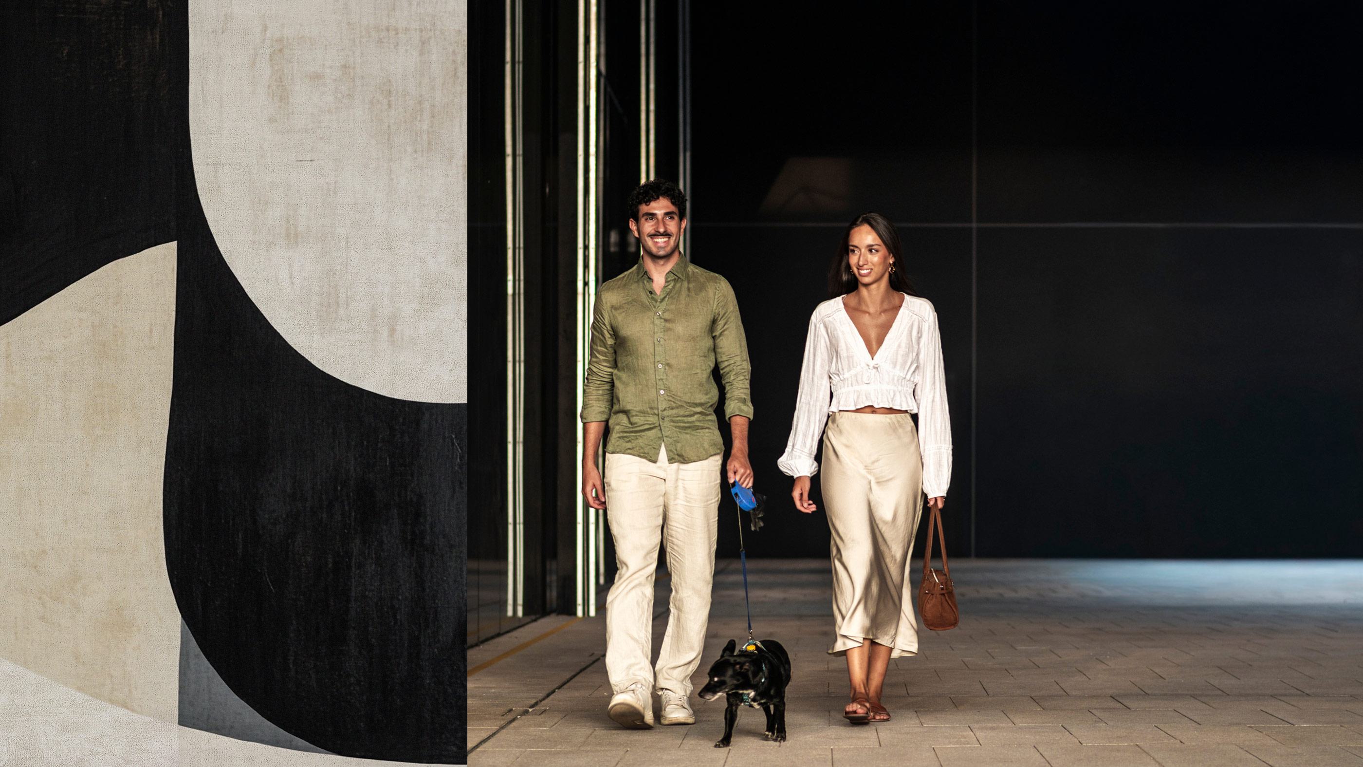 Couple walking dog in the city