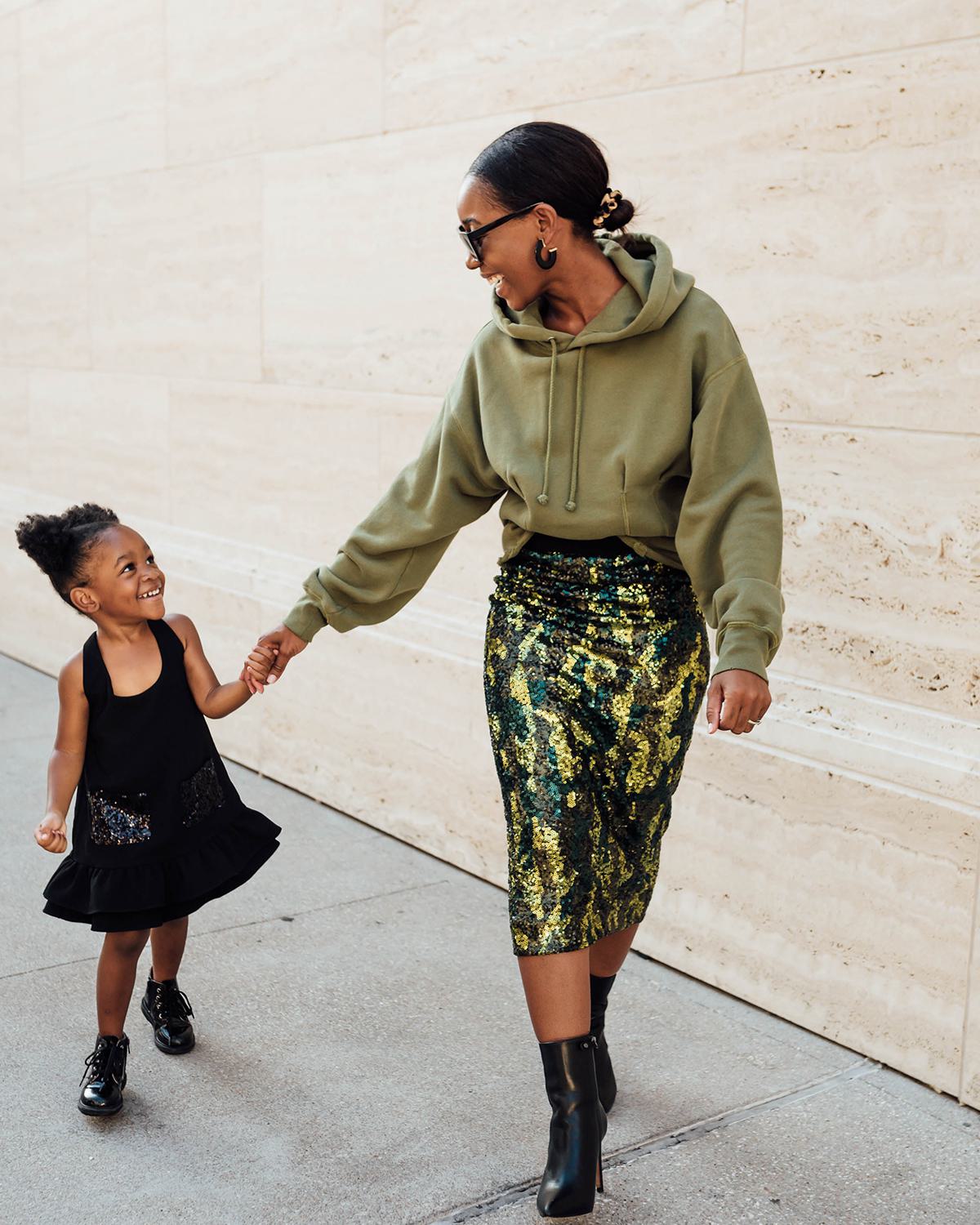 Mother and daughter walking on street