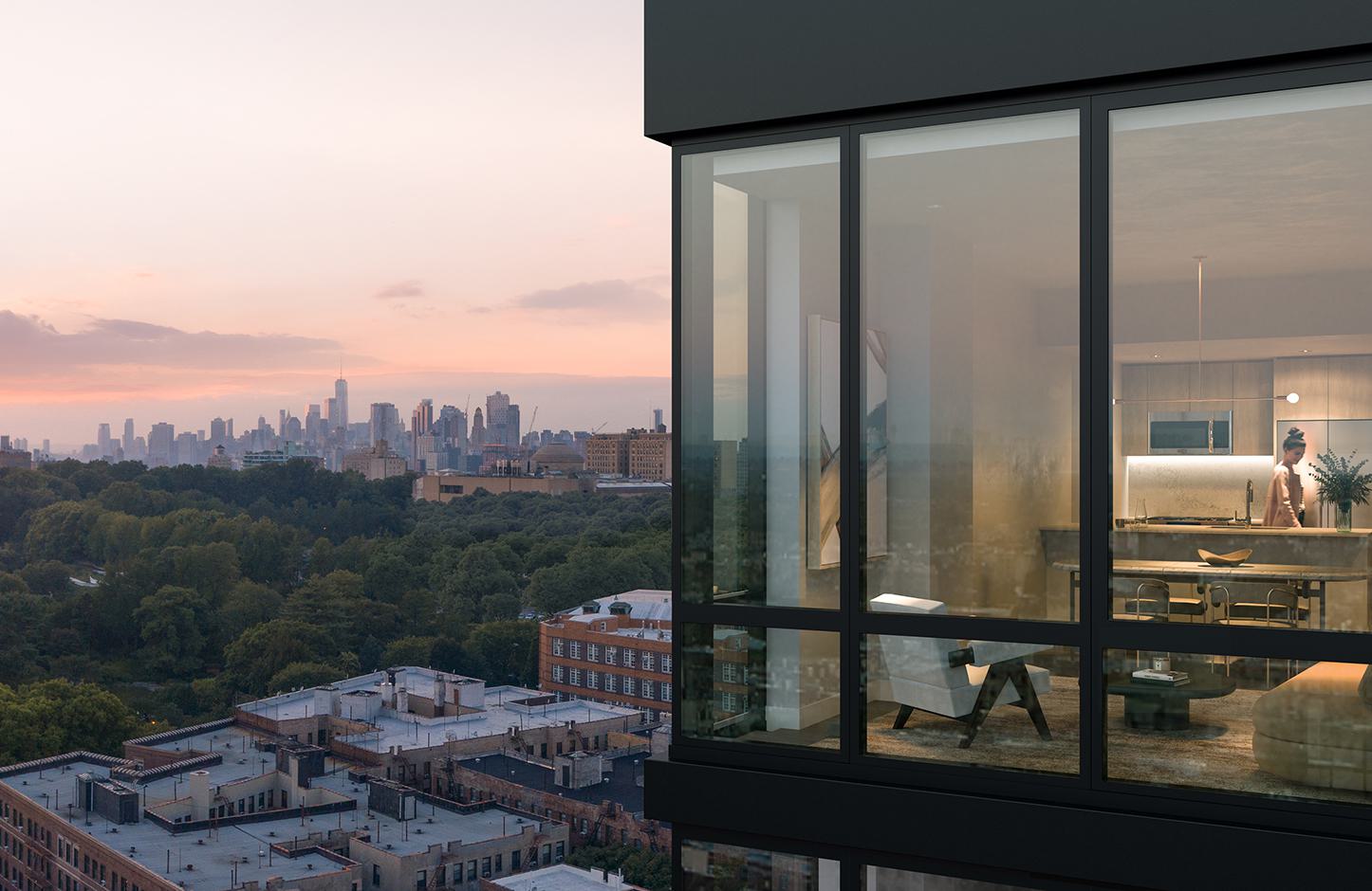 View from a Loden residence at dusk, showing expansive windows overlooking Prospect Park’s treetops and the Manhattan skyline in the distance.