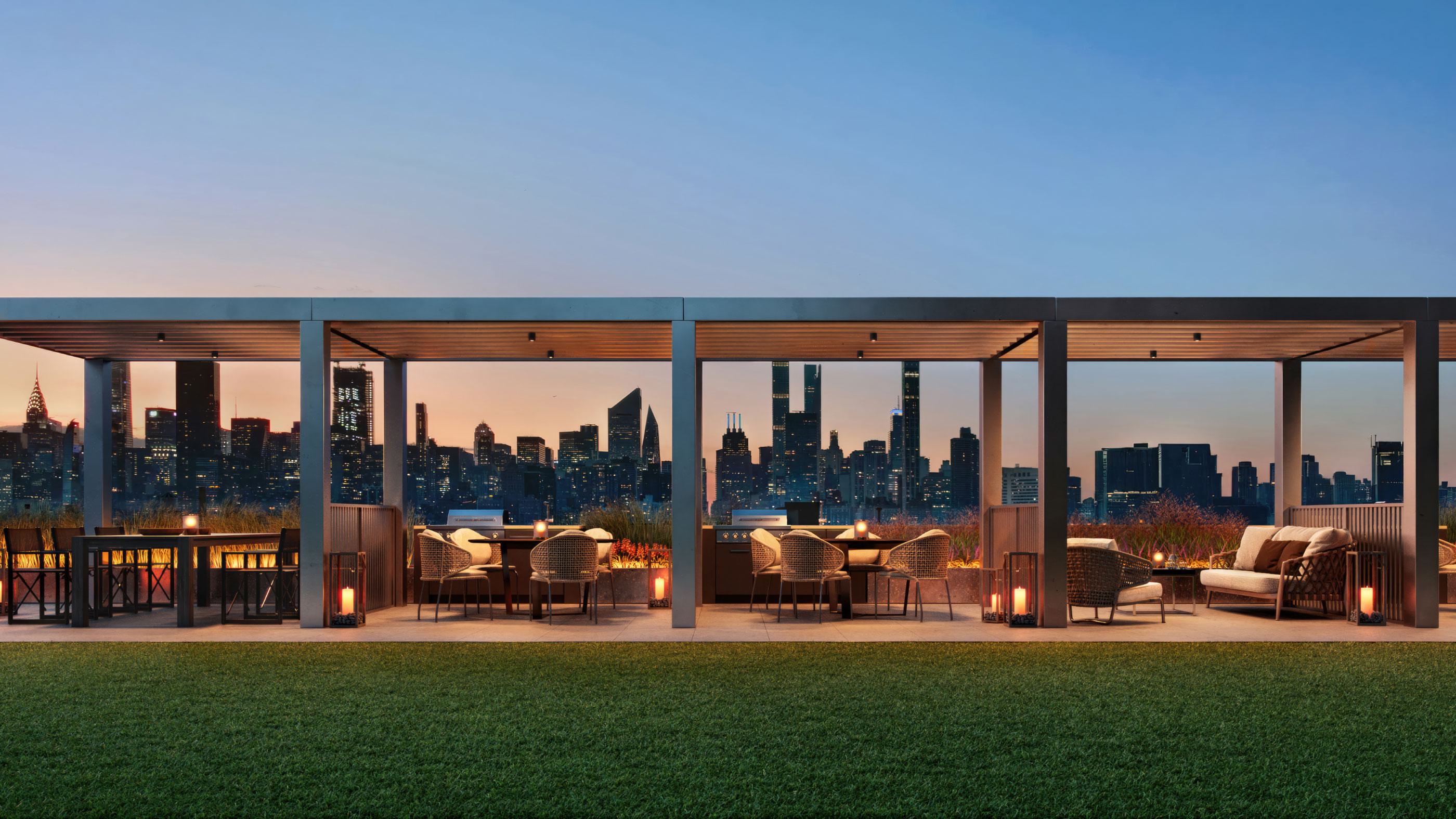 Rooftop dining terraces at Lumen LIC with pergolas, lounge seating, and warm lantern lighting, overlooking the Manhattan skyline at sunset.