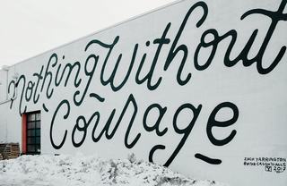 colorful outdoor mural reading "nothing without courage" 