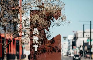 galvanized street sign reading "ART"