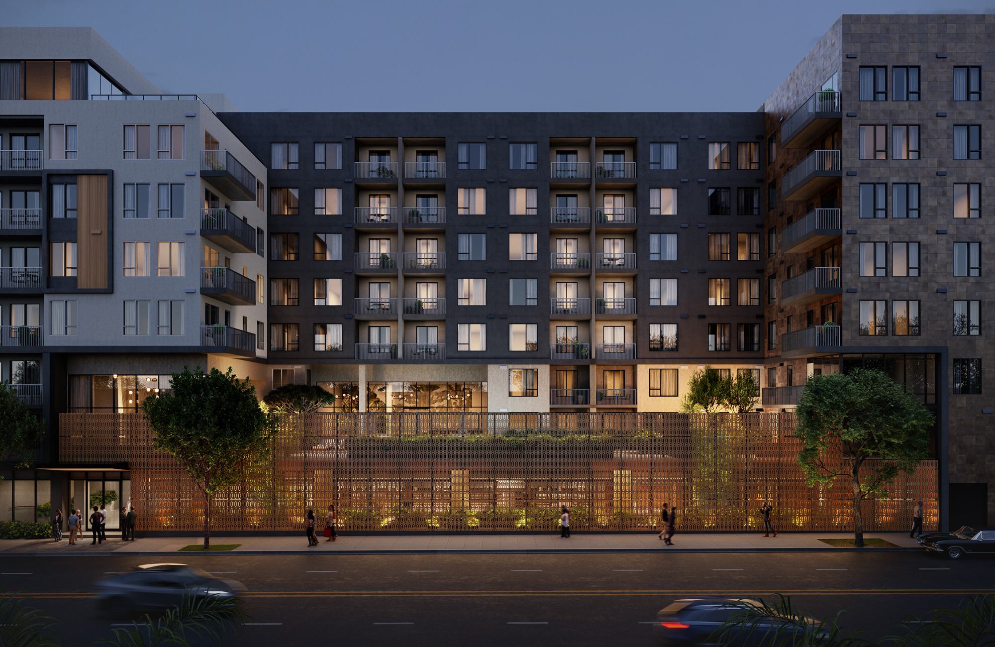 Evening exterior view of Rowyn Apartments in Hillcrest, featuring a contemporary mid-rise facade with balconies, landscaped street frontage, and warm interior lighting along a tree-lined avenue.