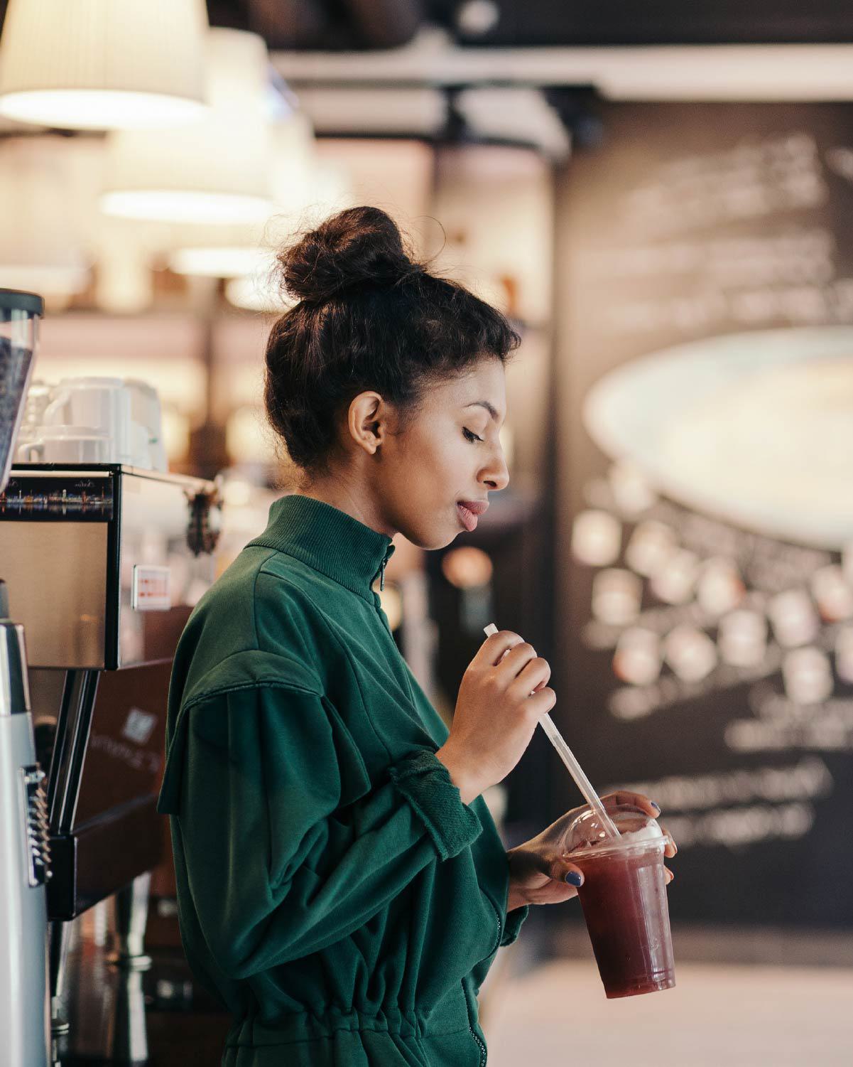 A young woman enjoys a drink in a Belred neighborhood coffee shop