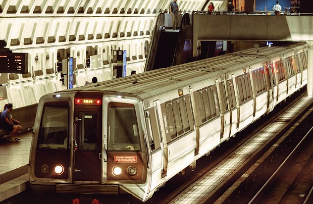 Washington Metro train arriving at an underground station with the system’s iconic coffered concrete ceiling