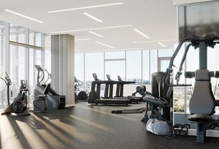 Bright ARQ fitness center with treadmills, ellipticals, and strength machines set against floor-to-ceiling windows and panoramic Los Angeles views