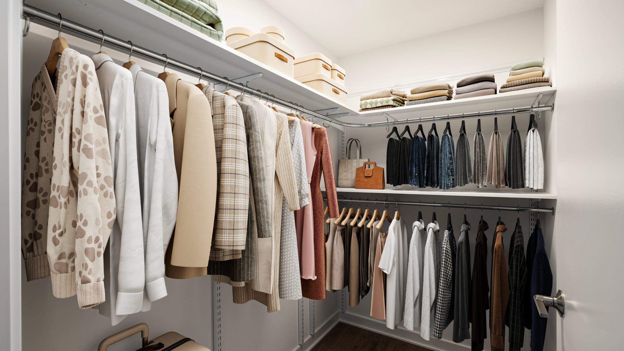 Spacious modular walk-in closet at Aerie featuring adjustable white shelving, multiple hanging rods, upper storage shelves with woven baskets, and ample floor space for a dresser or additional storage furniture.