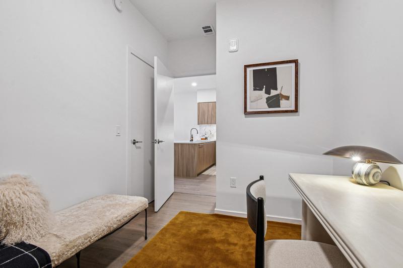 Cozy home office at Aerie with a wood desk, modern art, and bench seating