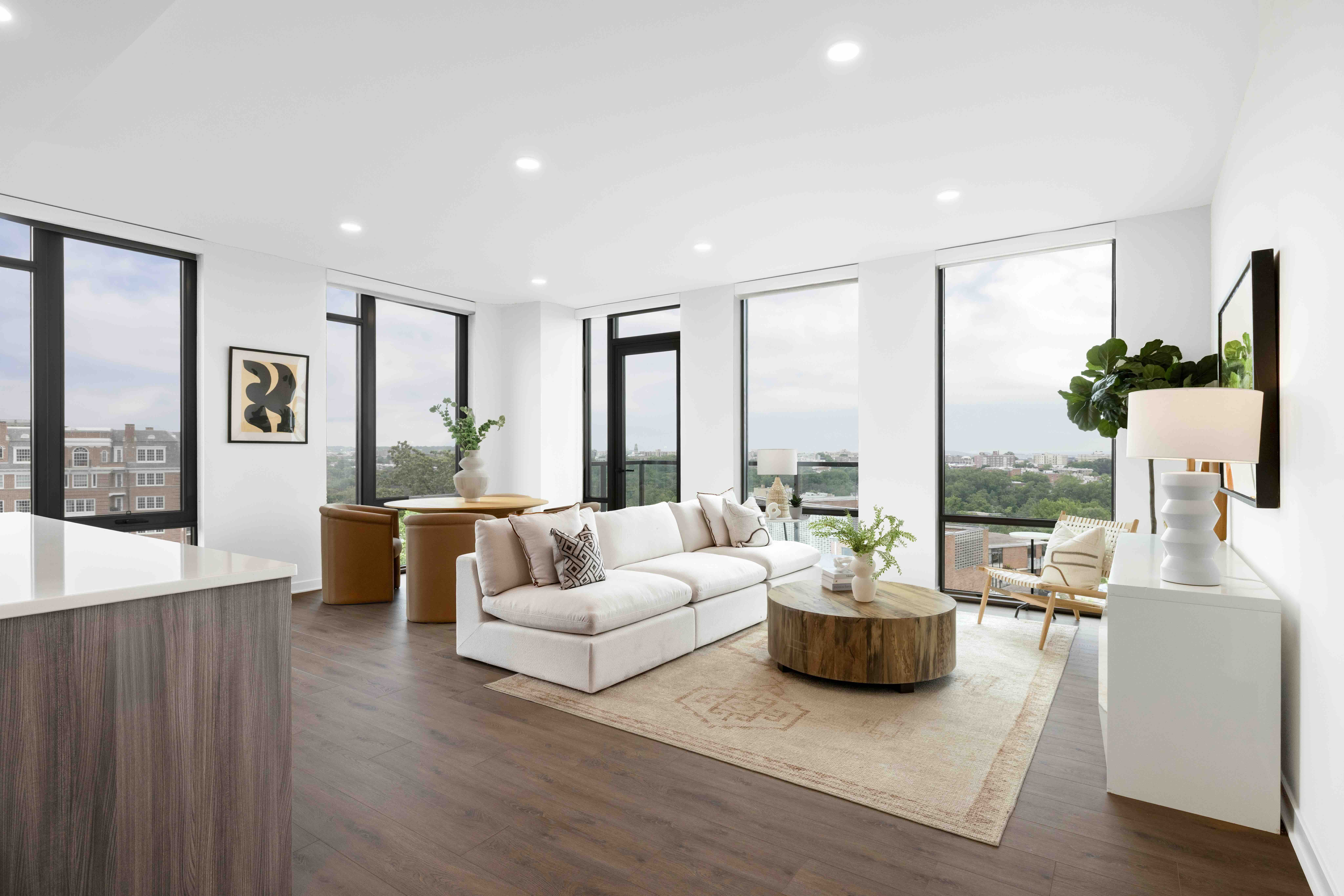 Open-concept penthouse living room with floor-to-ceiling windows and elevated DC views.