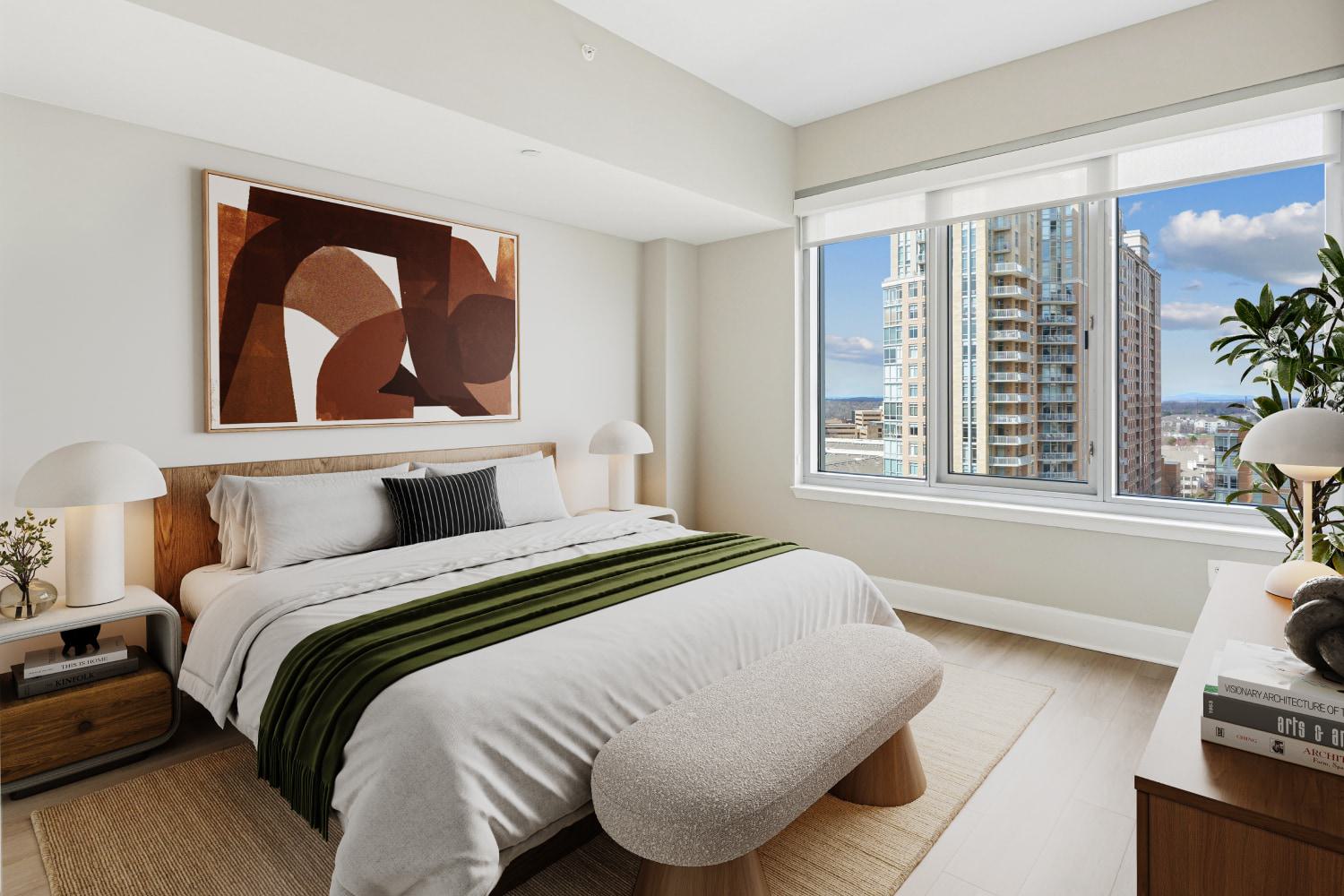 Contemporary apartment bedroom featuring a large window with high-rise views, a king bed, and abstract wall art.
