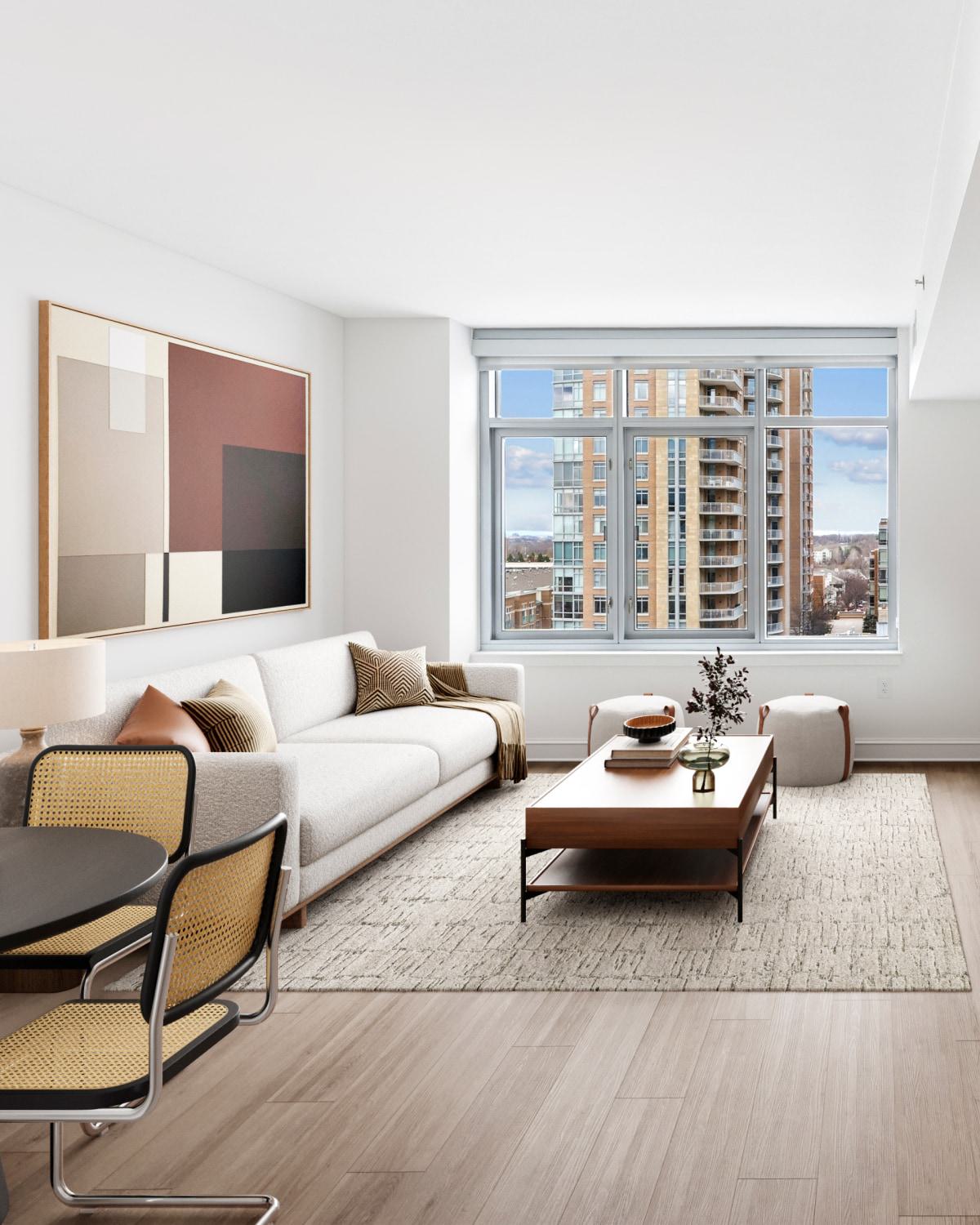 Sunlit apartment living room with a cream sofa, wooden coffee table, and city views through a large window.