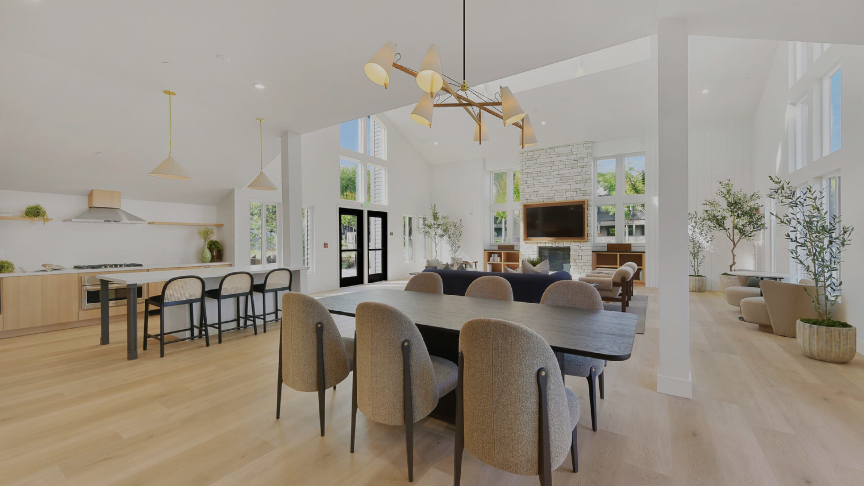 Stylish, coastal and upscale clubroom with open kitchen, fireplace and lounge seating