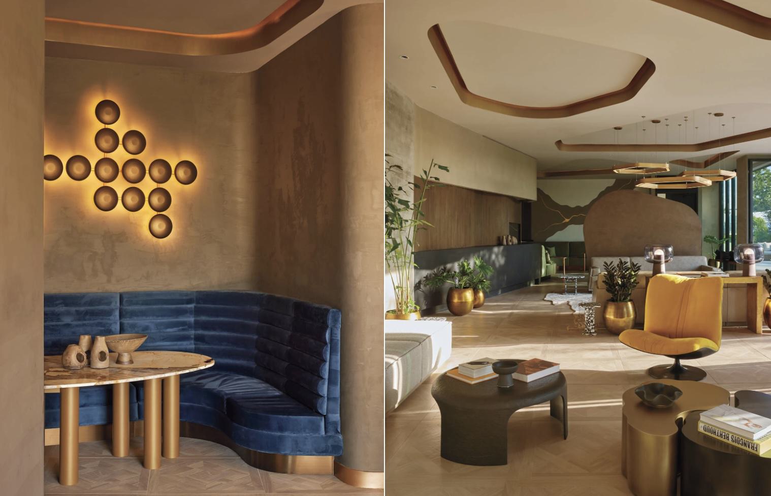 Split image showing two views of a sculptural residential lobby. Left: curved blue velvet banquette with brass pedestal table beneath circular backlit wall art on a plaster wall. Right: expansive lounge with herringbone wood floors, rounded ceiling details, mustard accent chair, sculptural coffee tables, brass planters, and layered lighting.