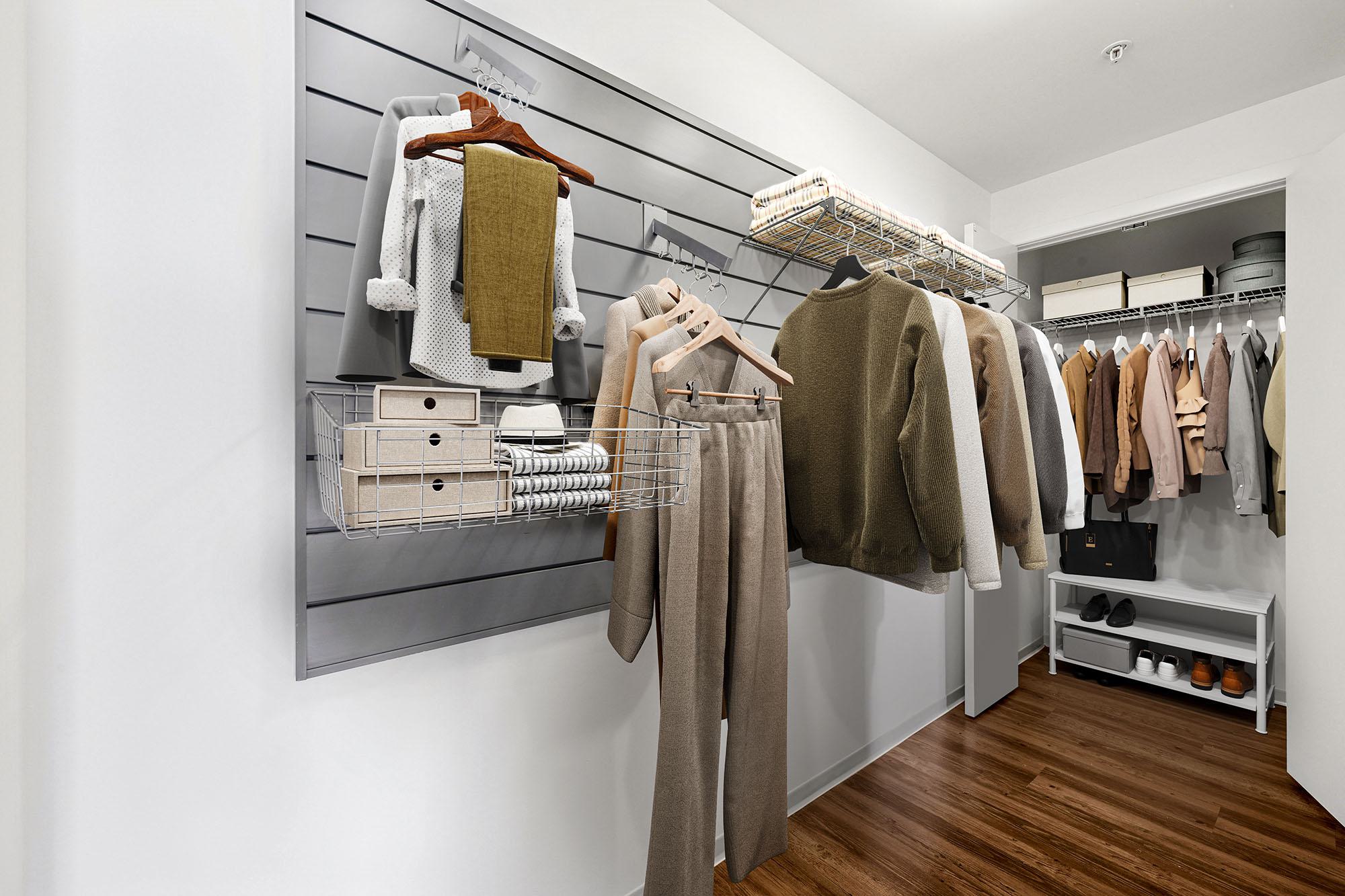 Walk-in closet at Luka on the Common with open shelving, hanging sections, and wire baskets for organized clothing and accessory storage.