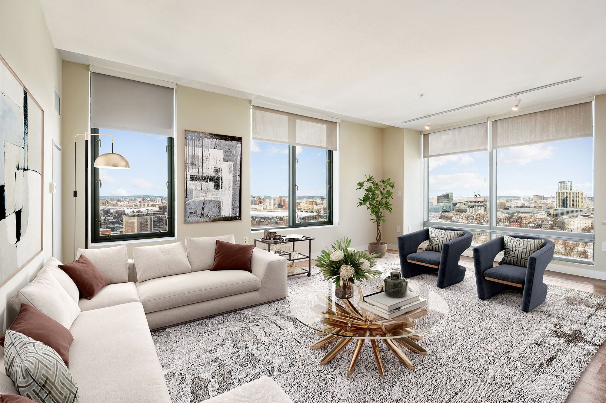 Living room at Luka on the Common with oversized windows framing panoramic views of Boston’s skyline and Boston Common.