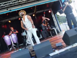 outdoor performers at Columbia City night market with man singing and backup band 