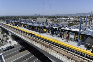Commuters boarding the Metro E Line at the Expo/Sepulveda Station, highlighting the car-free transit options and modern infrastructure of West LA.