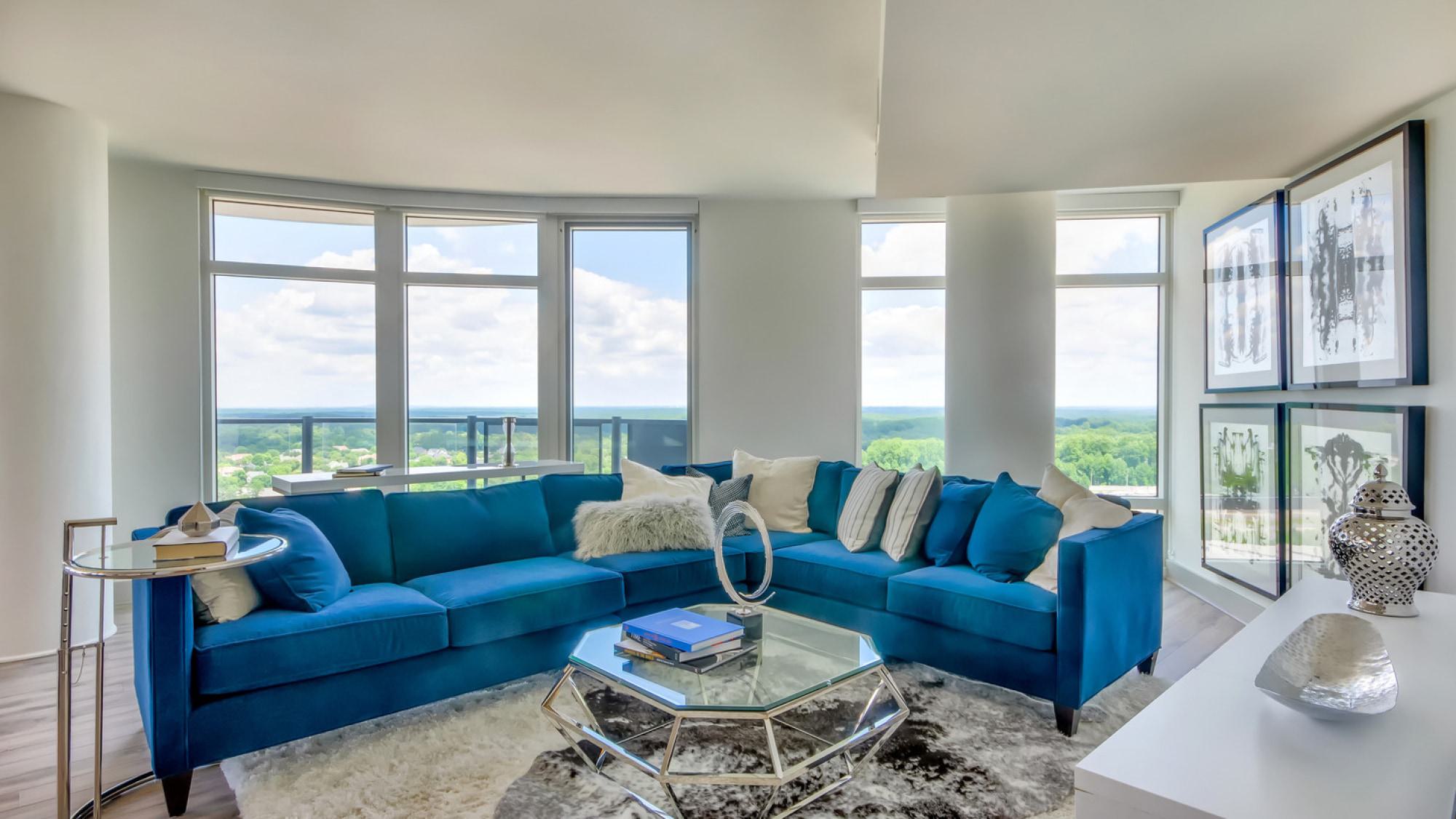 living room at adaire tysons with floor-to-ceiling windows and scenic views of the tree canopy near Spring Hill, Tysons VA